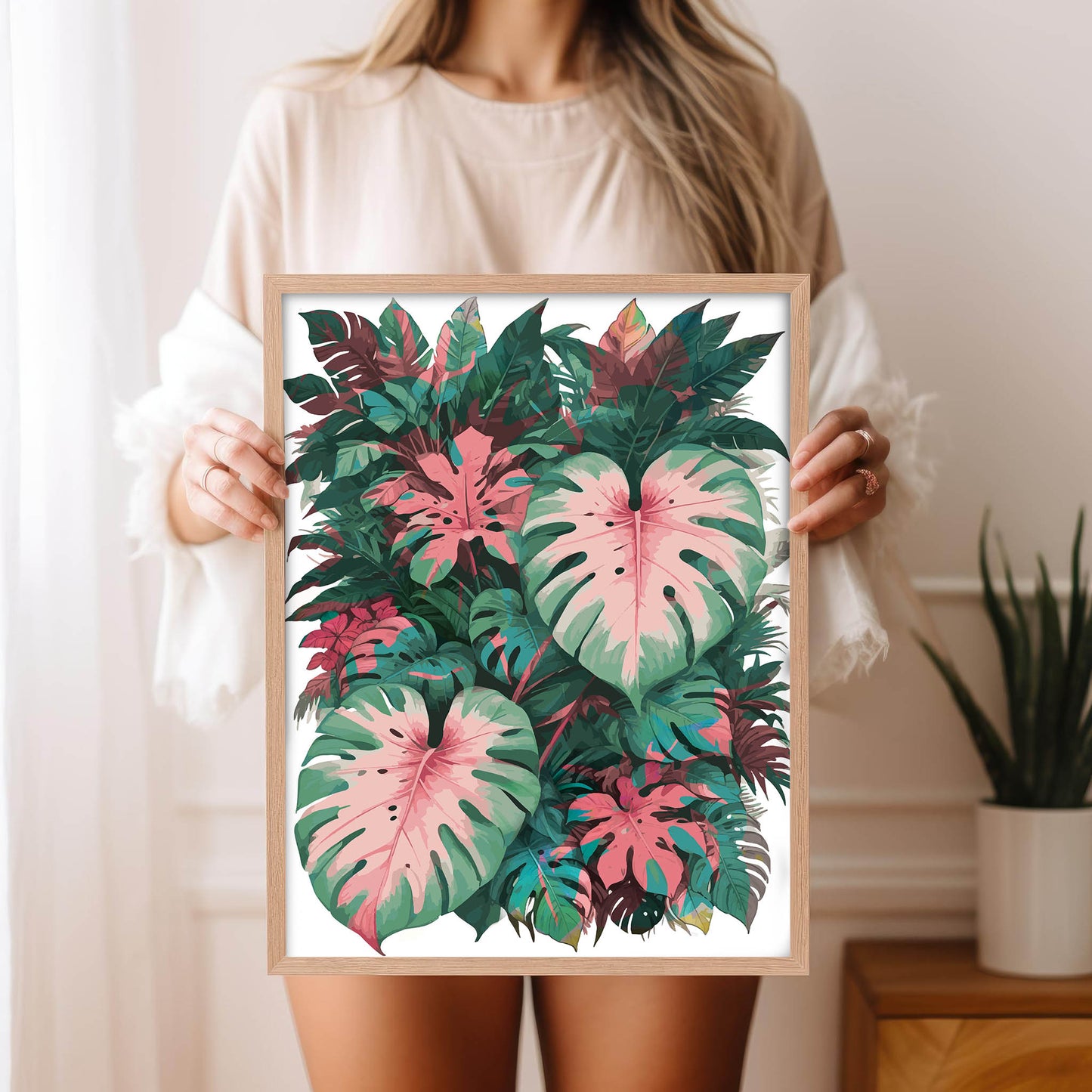 Tropical botanical printable wall art featuring a lush arrangement of pink and green monstera and philodendron leaves, ideal for jungle-themed or nature-inspired home decor.