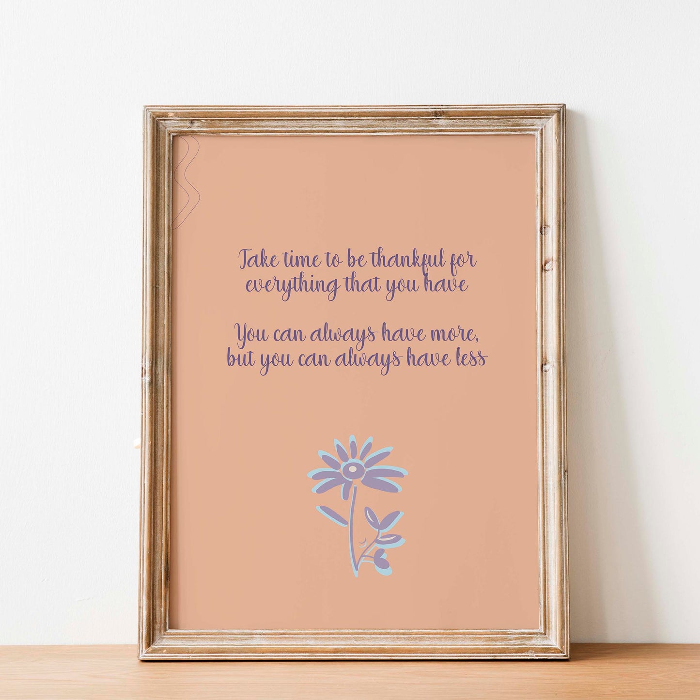 Gratitude-themed printable wall art featuring the quote 'Take time to be thankful for everything that you have. You can always have more, but you can always have less' in elegant purple script on a warm peach background, accented with a whimsical lavender and blue flower illustration, perfect for cozy home, mindfulness, or wellness decor