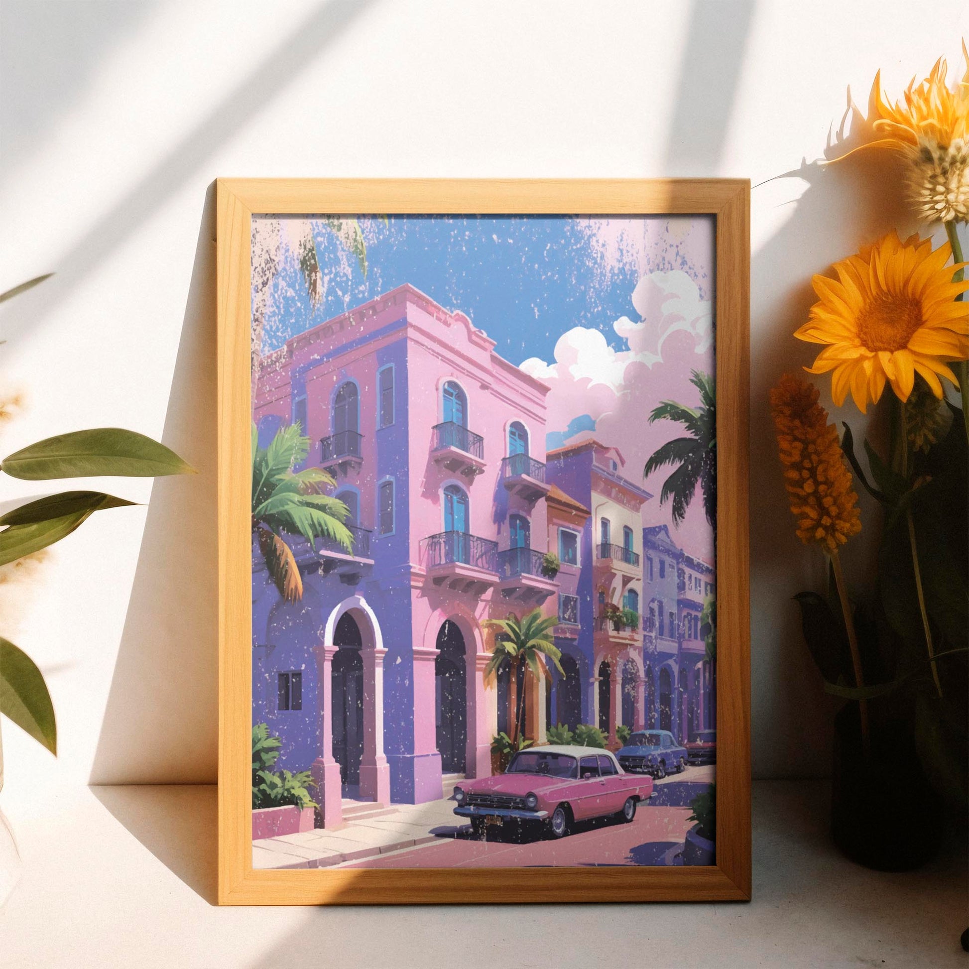 Printable wall art of colorful pastel buildings with balconies, palm trees, and a vintage pink car parked on the street under a sunny sky, perfect for tropical, retro-inspired home decor
