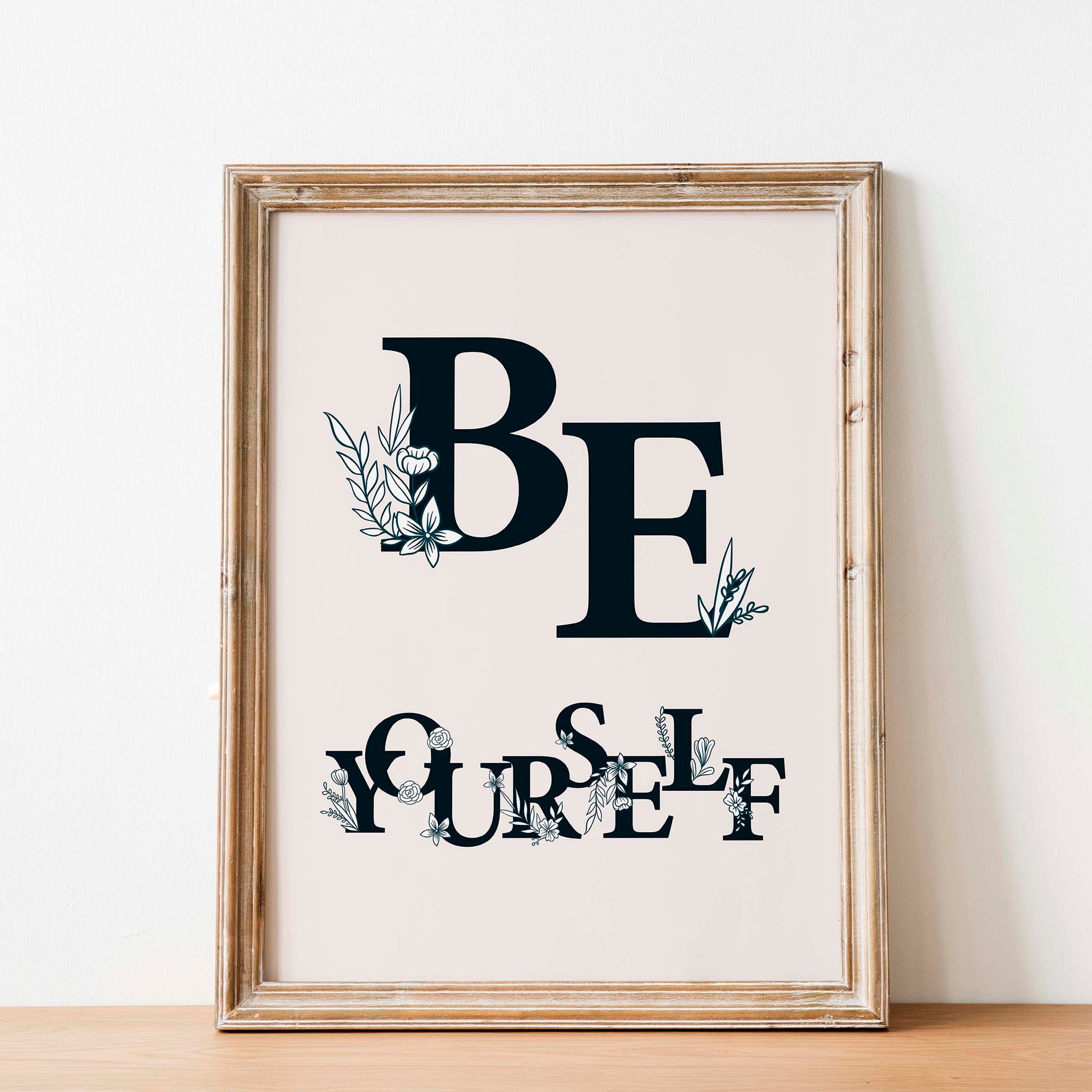 Aesthetic floral-themed printable wall art featuring the motivational phrase 'Be Yourself' in bold black serif typography decorated with delicate botanical illustrations, set against a soft beige background with natural light - ideal for bedroom, dorm, or creative space decor