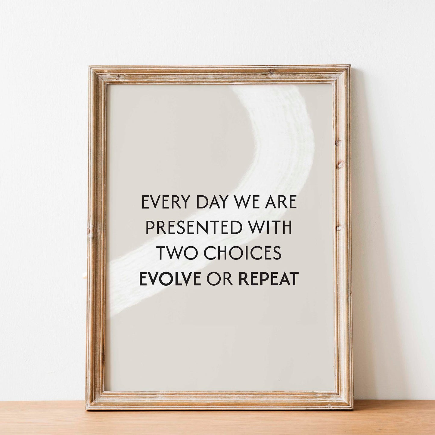 Motivational printable wall art with the quote 'Every day we are presented with two choices - evolve or repeat' in bold black typography on a neutral beige background with abstract white brushstroke - ideal for mindset, growth, or self-improvement decor