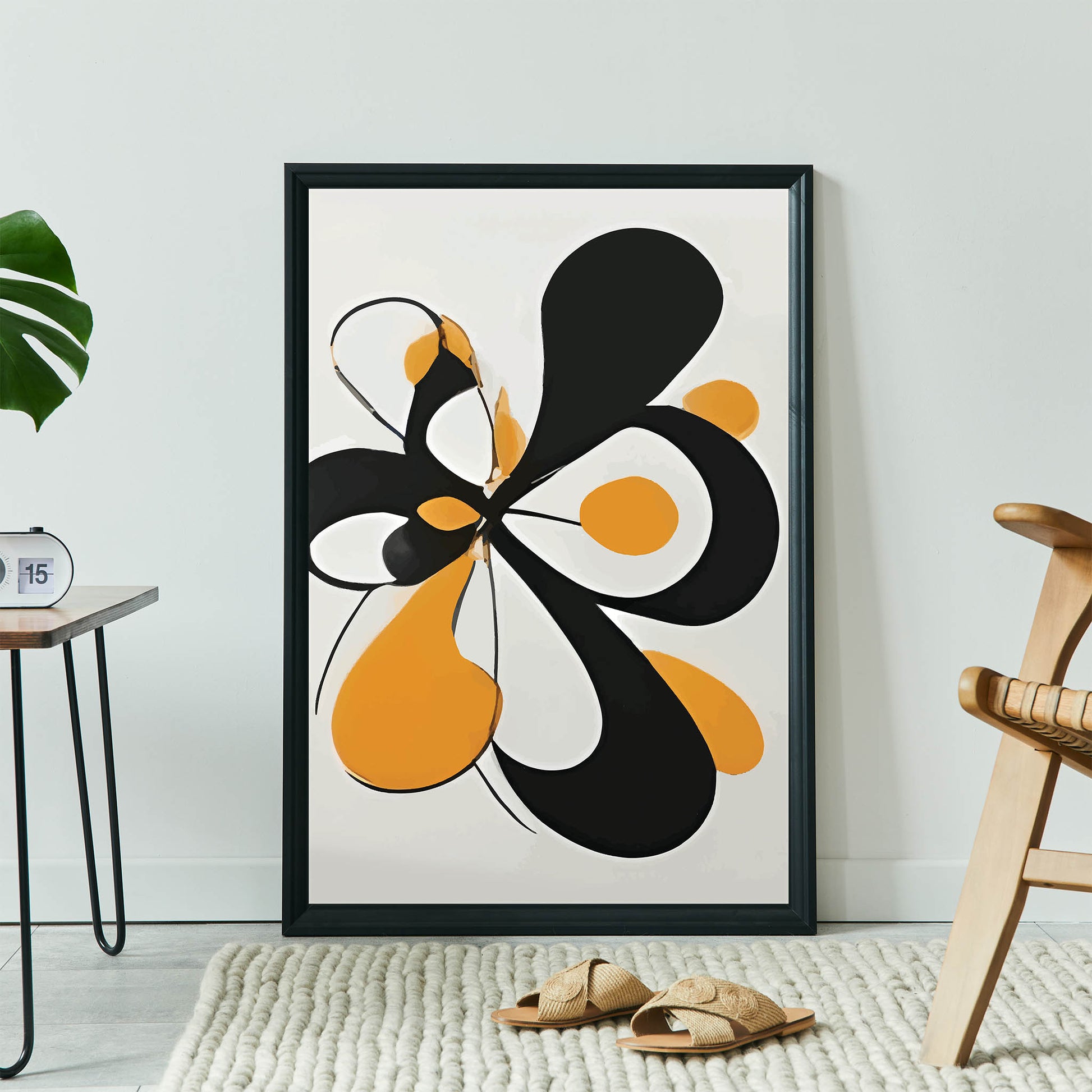 Modern abstract wall art featuring bold black and orange organic shapes with smooth curves on a light background