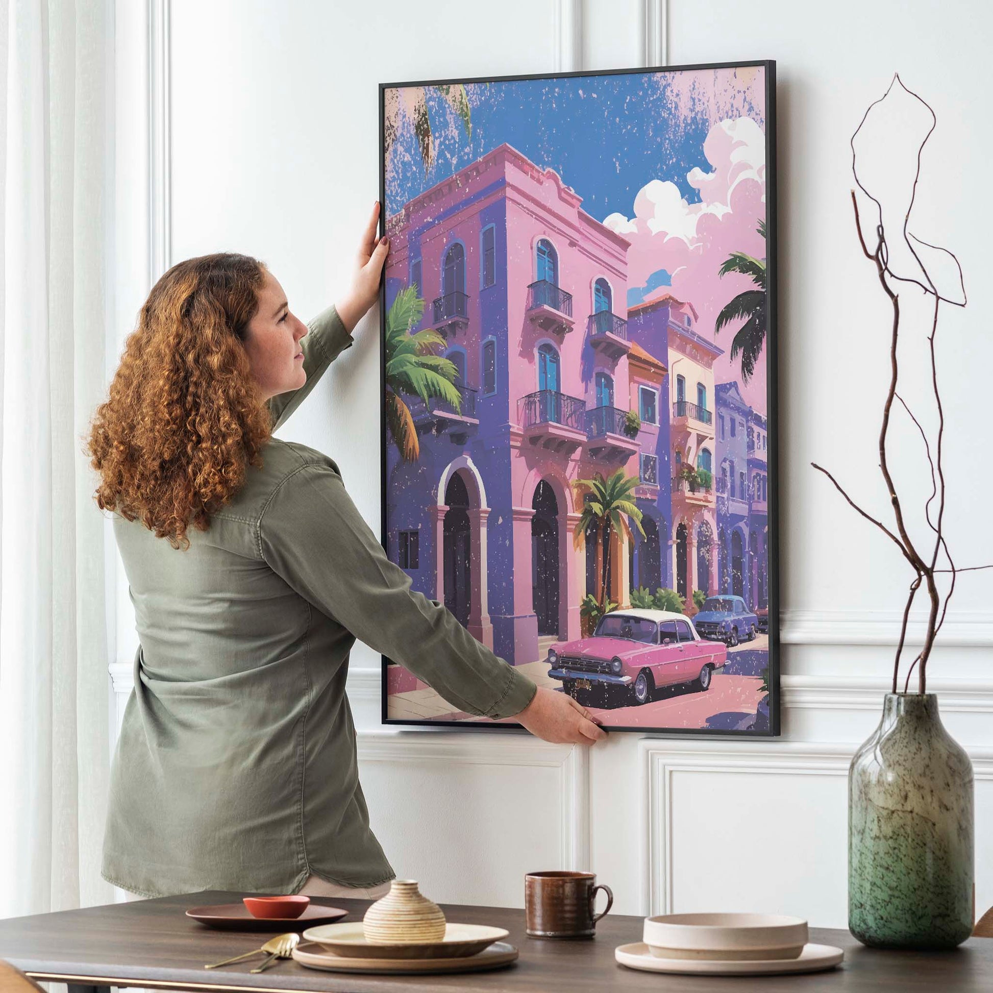 Printable wall art of colorful pastel buildings with balconies, palm trees, and a vintage pink car parked on the street under a sunny sky, perfect for tropical, retro-inspired home decor