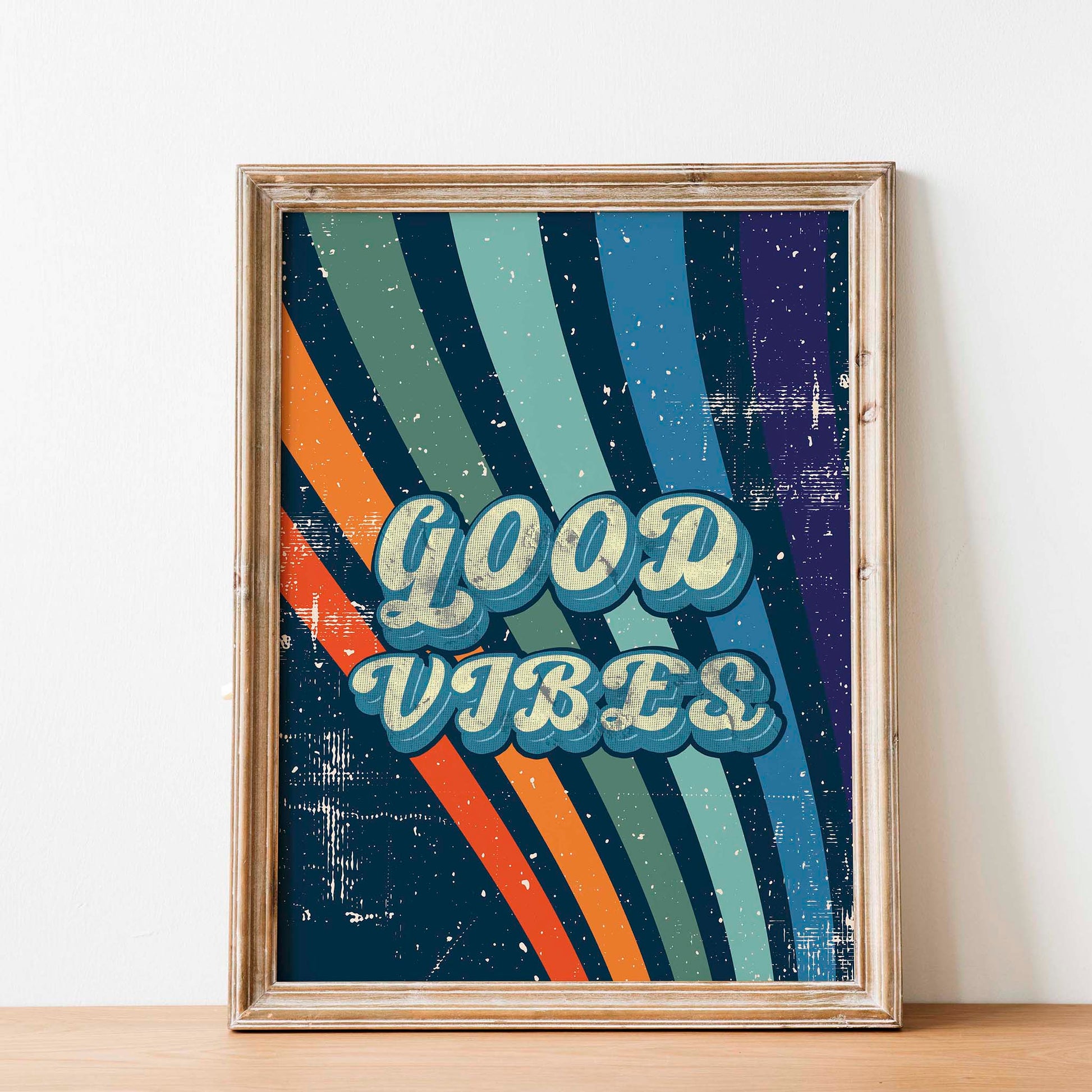 Printable wall art with a retro ‘Good Vibes’ typography in bold vintage-style letters, over a colorful striped background with a distressed, textured finish, perfect for positive, nostalgic home decor