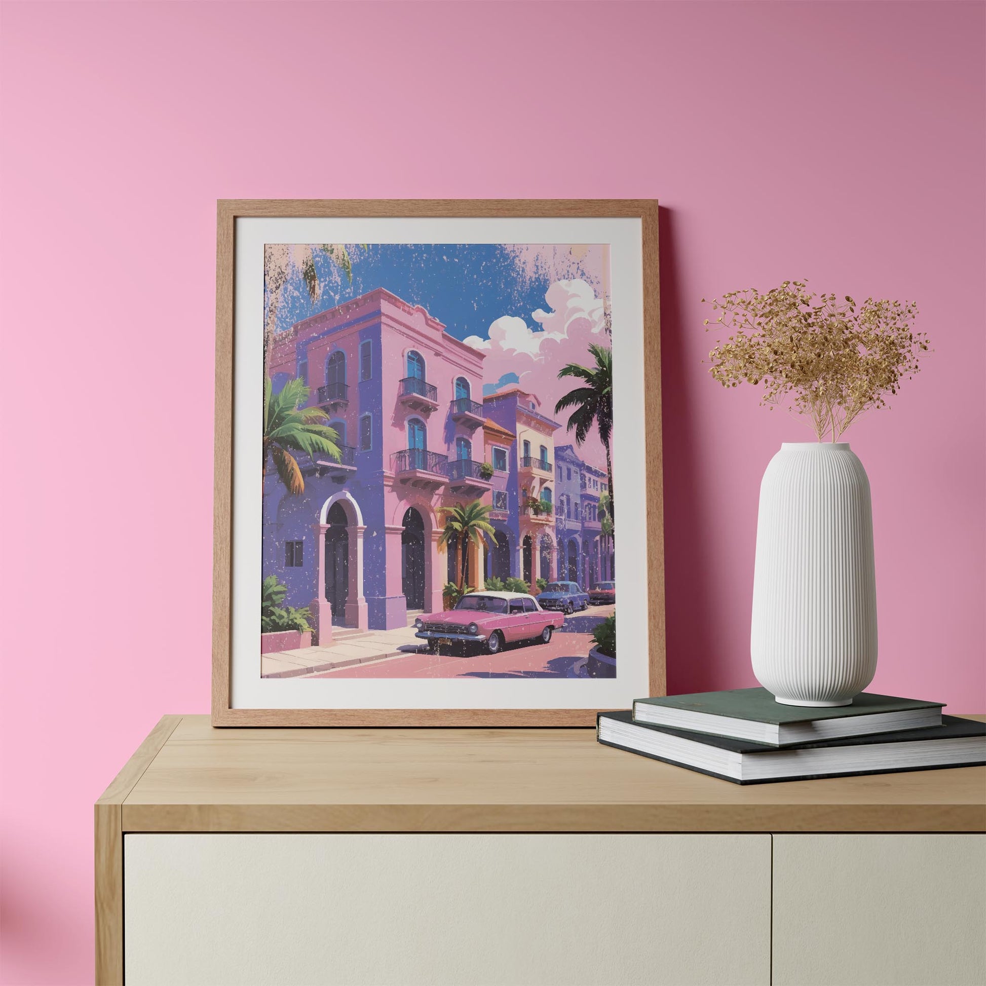 Printable wall art of colorful pastel buildings with balconies, palm trees, and a vintage pink car parked on the street under a sunny sky, perfect for tropical, retro-inspired home decor