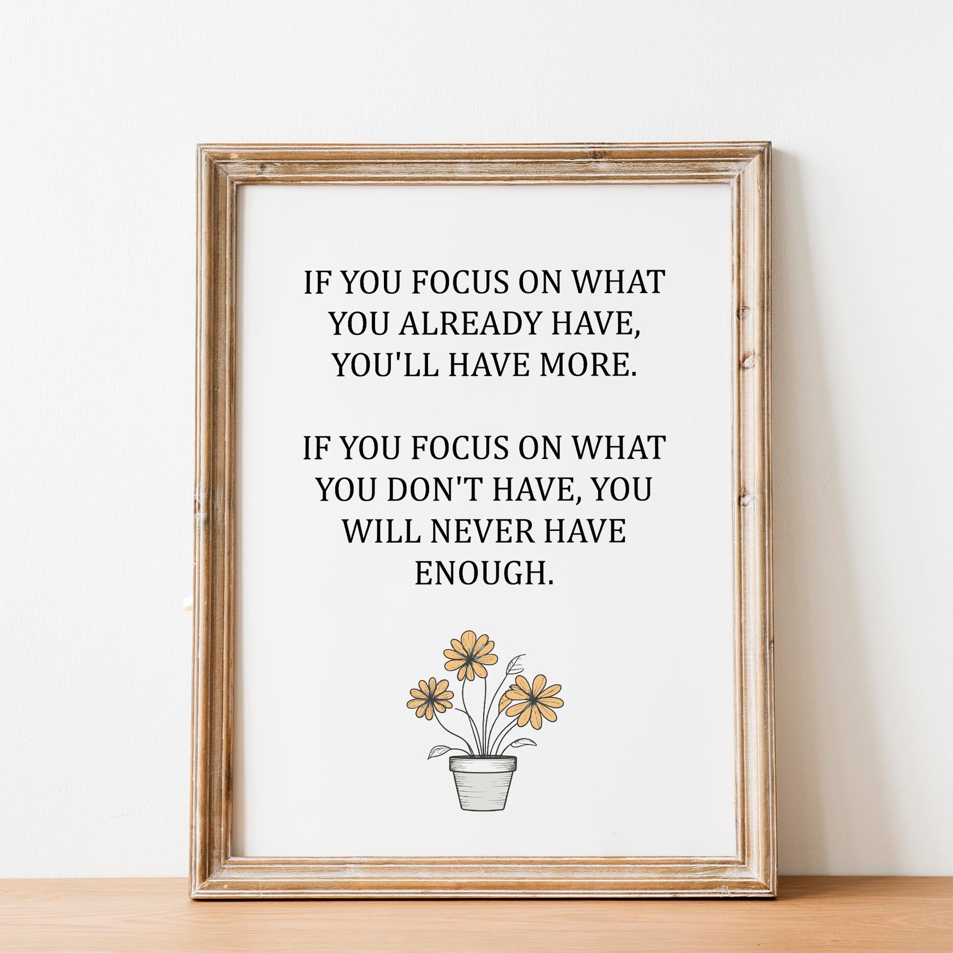Inspirational printable wall art featuring the quote 'If you focus on what you already have, you'll have more. If you focus on what you don't have, you will never have enough,' with a simple daisy flower pot illustration and soft neutral background, ideal for gratitude-focused or minimalist decor