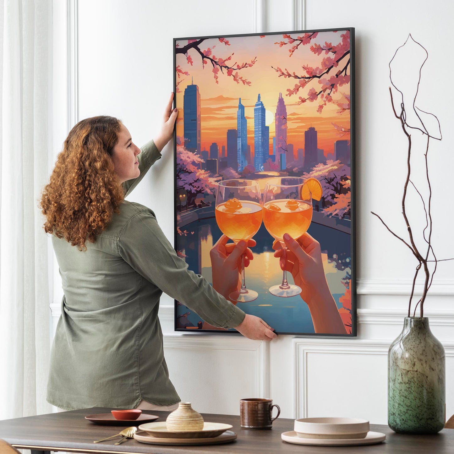 Romantic printable wall art featuring two hands holding glasses of orange cocktails at sunset, with a city skyline and cherry blossom trees in the background - perfect for modern and cozy home decor