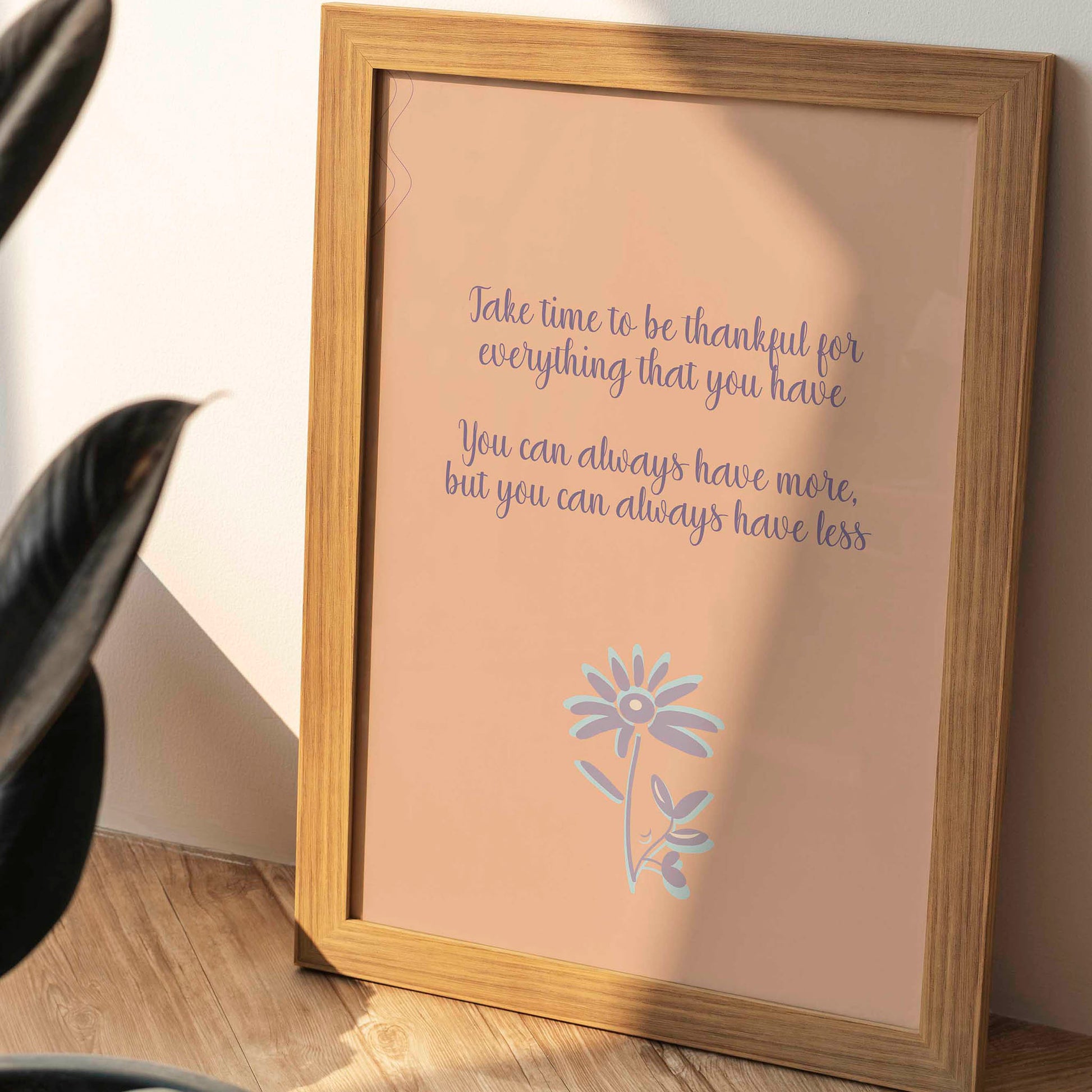 Gratitude-themed printable wall art featuring the quote 'Take time to be thankful for everything that you have. You can always have more, but you can always have less' in elegant purple script on a warm peach background, accented with a whimsical lavender and blue flower illustration, perfect for cozy home, mindfulness, or wellness decor