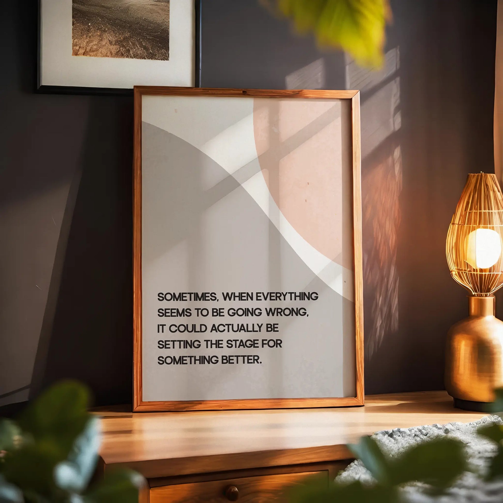 Modern motivational printable wall art featuring the quote 'Sometimes, when everything seems to be going wrong, it could actually be setting the stage for something better' in black text over abstract curved shapes in soft beige and peach tones, perfect for uplifting and calming interior spaces