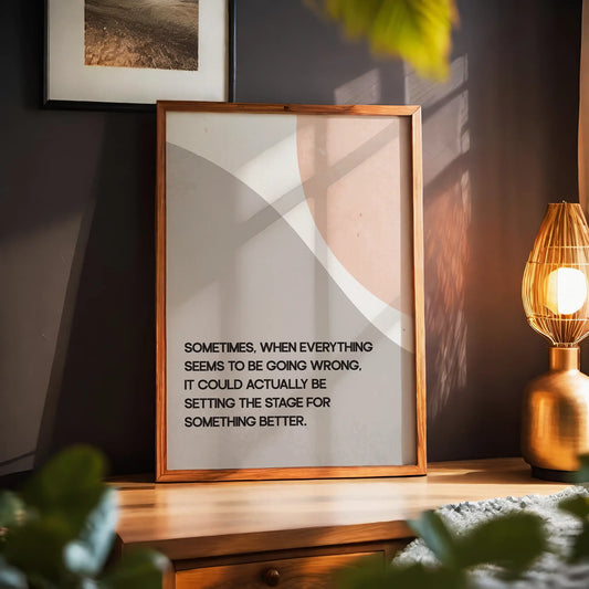 Modern motivational printable wall art featuring the quote 'Sometimes, when everything seems to be going wrong, it could actually be setting the stage for something better' in black text over abstract curved shapes in soft beige and peach tones, perfect for uplifting and calming interior spaces