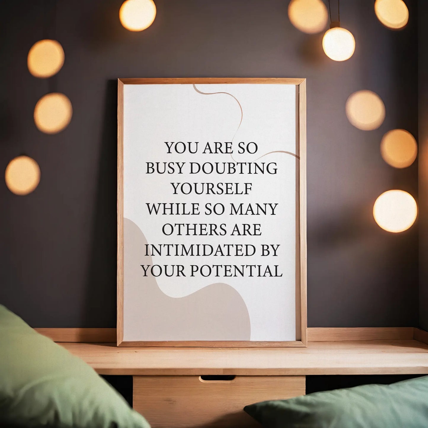 Empowering printable wall art featuring the quote 'You are so busy doubting yourself while so many others are intimidated by your potential' in classic black serif font on a soft beige background with abstract curved shapes, perfect for confidence-boosting home, office, or studio decor