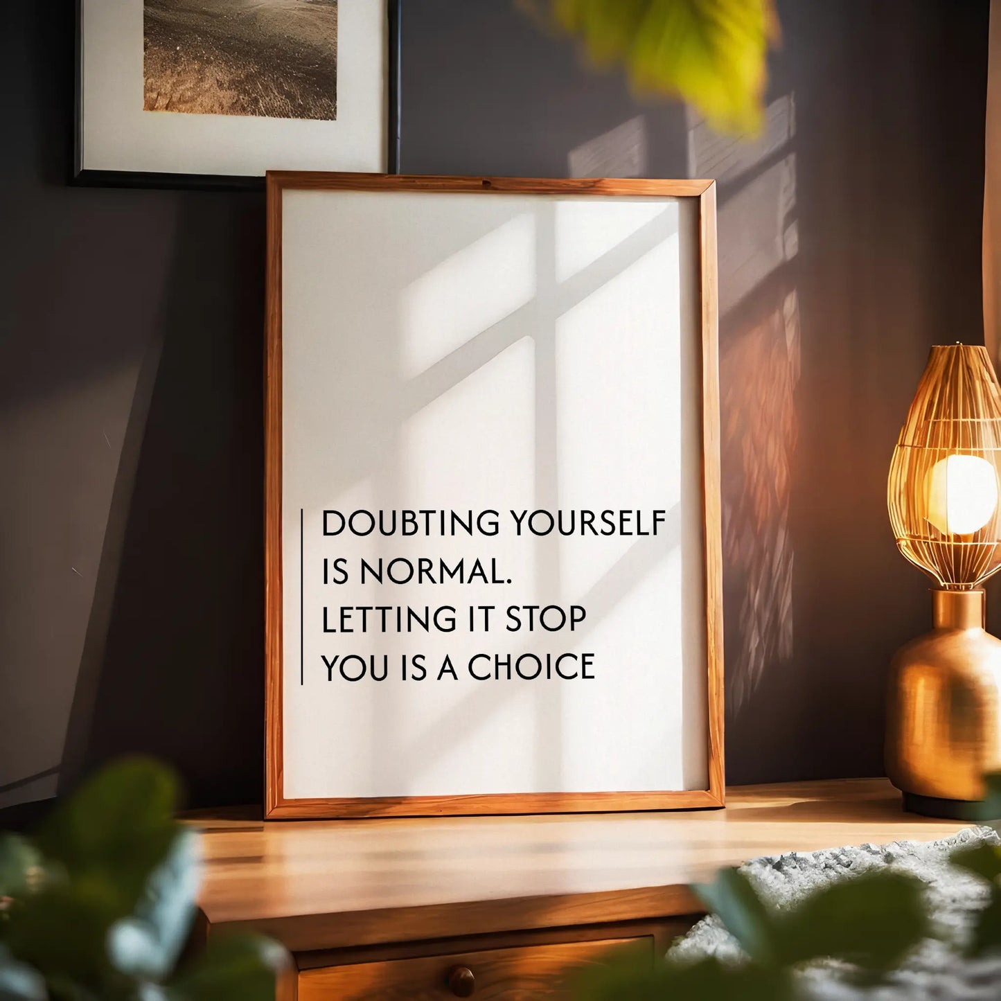 Minimalist motivational printable wall art with the quote 'Doubting yourself is normal. Letting it stop you is a choice' in clean black typography, set against a soft beige background with natural window light - ideal for office, bedroom, or personal growth spaces