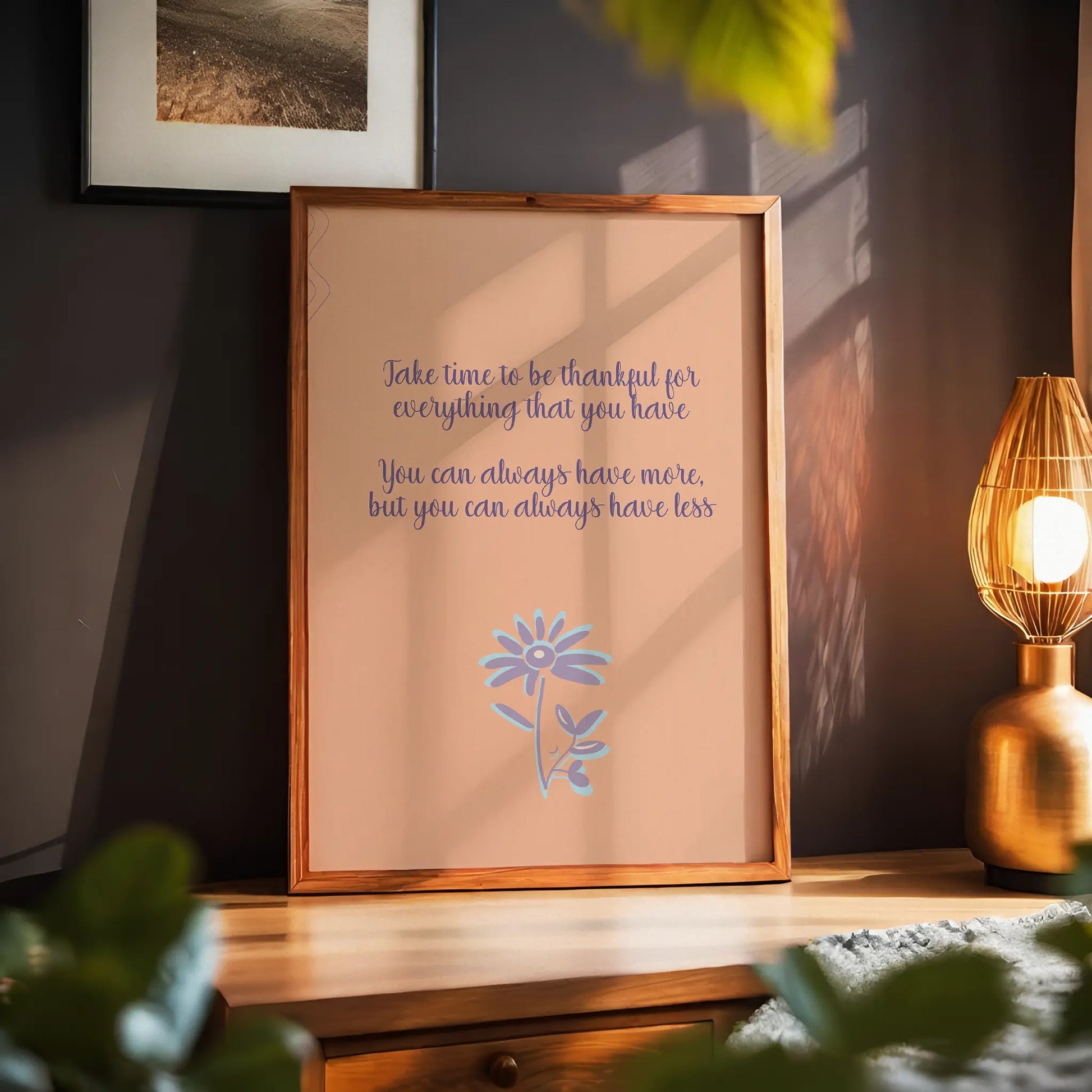 Gratitude-themed printable wall art featuring the quote 'Take time to be thankful for everything that you have. You can always have more, but you can always have less' in elegant purple script on a warm peach background, accented with a whimsical lavender and blue flower illustration, perfect for cozy home, mindfulness, or wellness decor