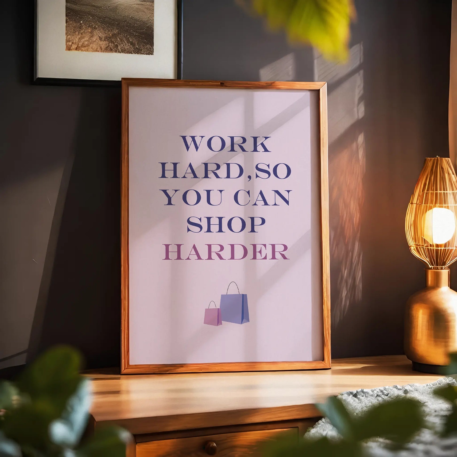 Chic and motivational printable wall art featuring the quote 'Work hard, so you can shop harder' in bold purple and pink gradient typography, with shopping bag illustrations on a soft pink background – perfect for fashion lovers, boutique decor, or glam office spaces