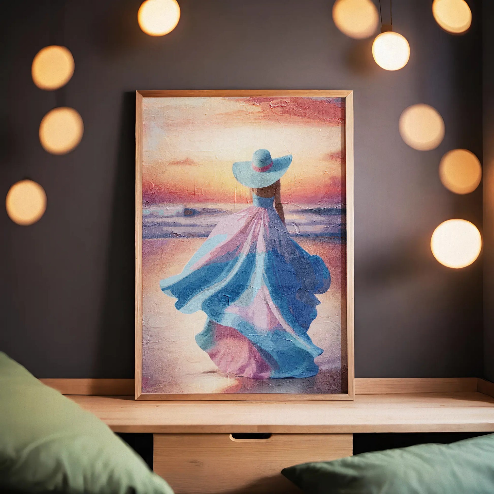Elegant printable wall art of a woman in a flowing pastel pink and blue dress with a matching wide-brimmed hat, walking along the beach at sunset with soft waves and a glowing sky - perfect for feminine, coastal, or romantic-themed decor