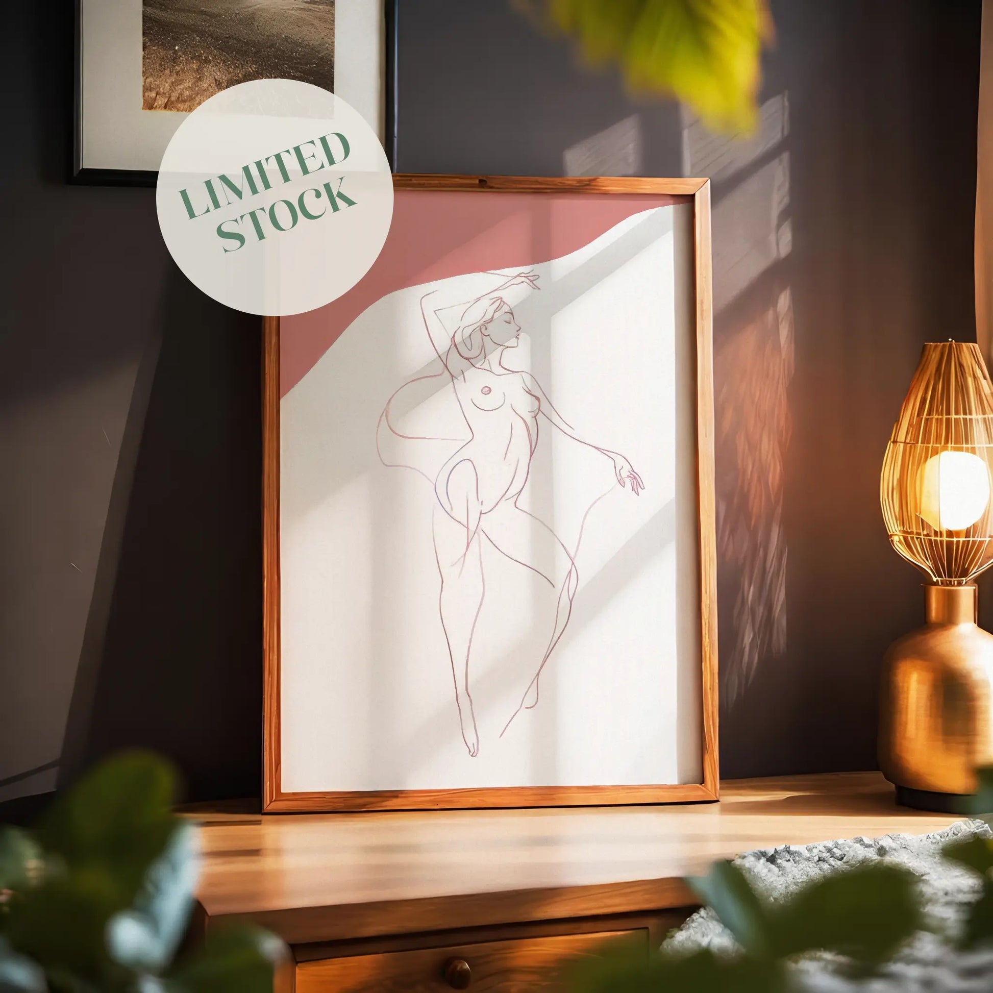 Minimalist line drawing of a nude female figure in a graceful pose with soft pink accents, elegant and sensual wall art ideal for modern bedrooms, studios, or gallery walls.