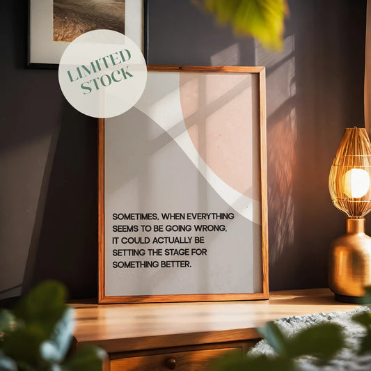 Modern motivational printable wall art featuring the quote 'Sometimes, when everything seems to be going wrong, it could actually be setting the stage for something better' in black text over abstract curved shapes in soft beige and peach tones, perfect for uplifting and calming interior spaces