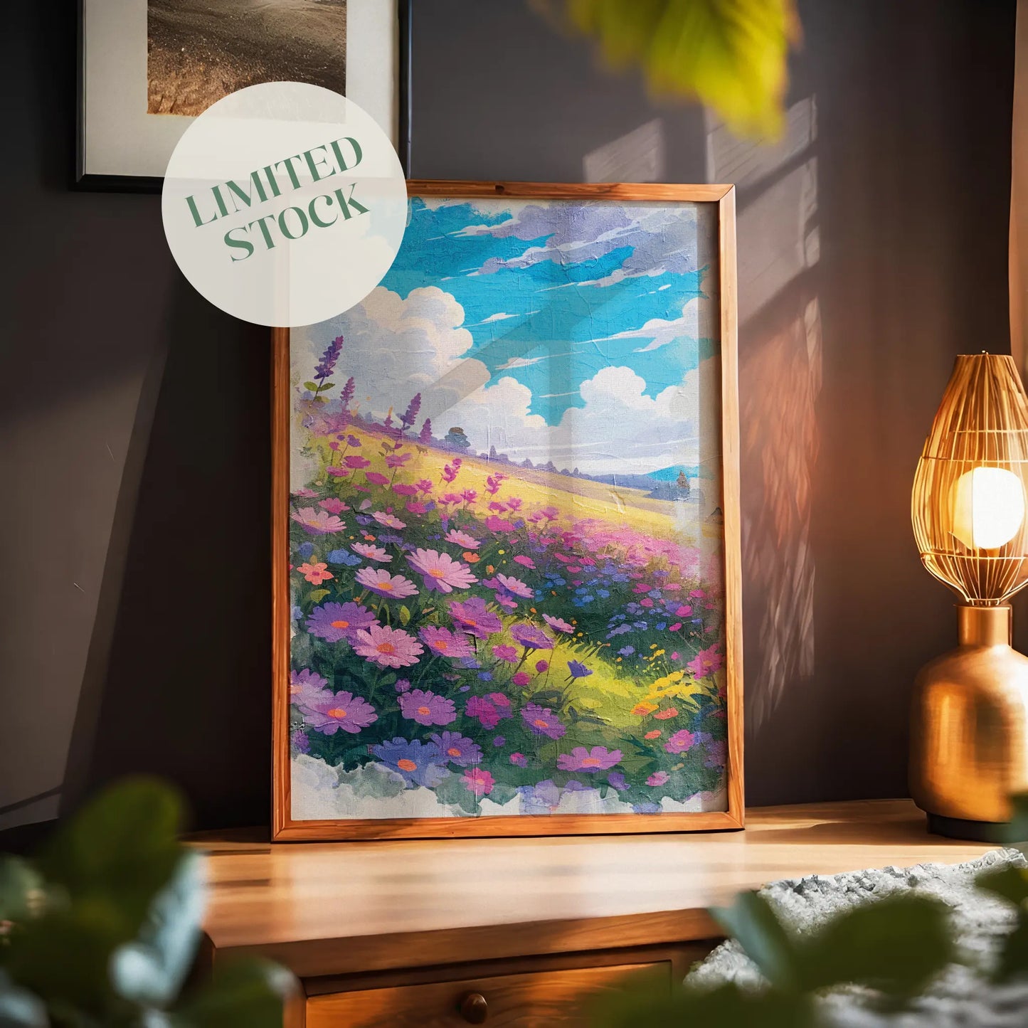 Vibrant printable wall art of a dreamy wildflower field in full bloom, featuring purple, pink, and blue blossoms under a bright blue sky with fluffy clouds, evoking warmth, joy, and a touch of whimsy