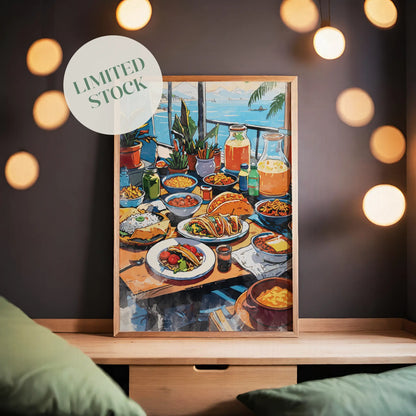 Colorful printable wall art of a festive Mexican dining table filled with tacos, rice, pasta, fresh vegetables, drinks, and juices, set against a scenic seaside view with potted plants and sailboats in the distance.