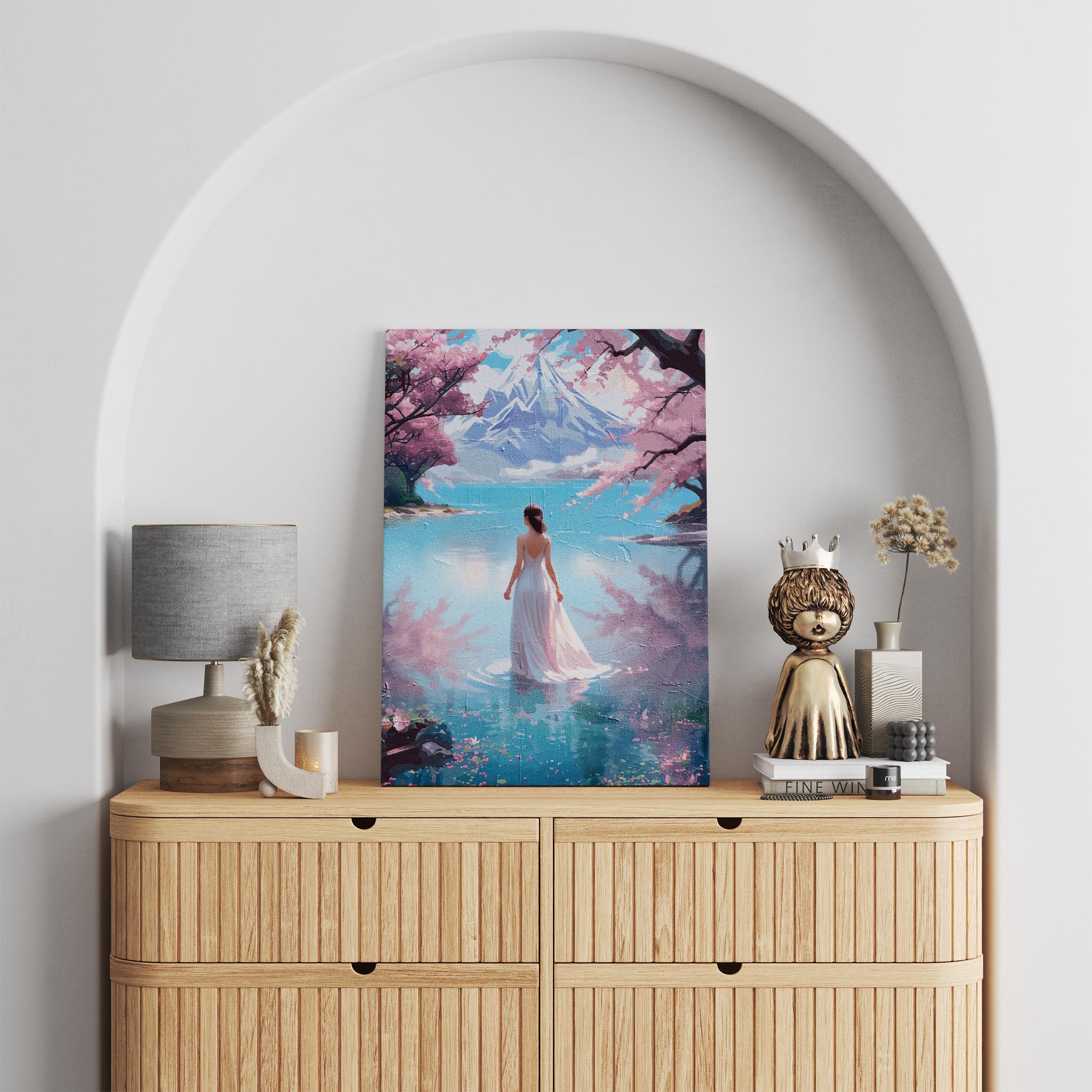 Dreamy landscape printable wall art of a woman in a flowing white gown standing in a serene lake, surrounded by cherry blossoms with a majestic snow-capped mountain in the background, ideal for tranquil, romantic, and nature-inspired interiors