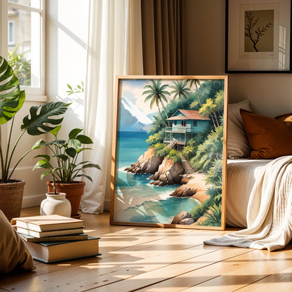 Tropical beach wall art of a wooden house on a cliff surrounded by palm trees, overlooking turquoise ocean waves with mountains in the background