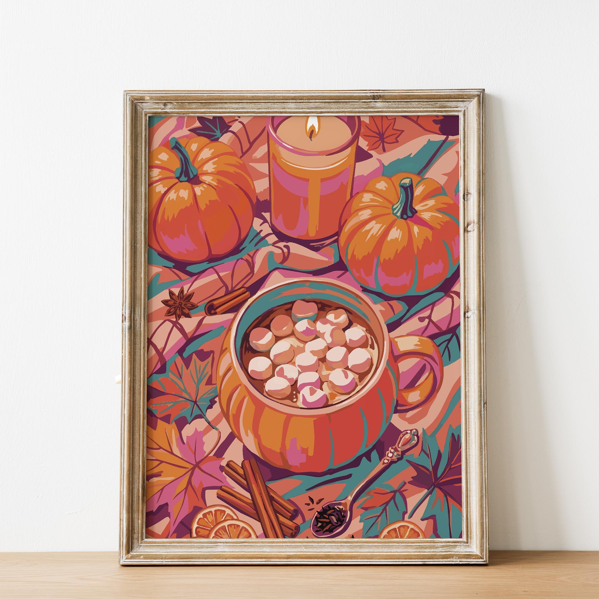 Maximalist cozy season wall art featuring an oversized illustrated pumpkin cocoa mug, lit glass candle, harvest pumpkins with teal stem accents, cinnamon sticks, and scattered autumn leaves in orange and pink