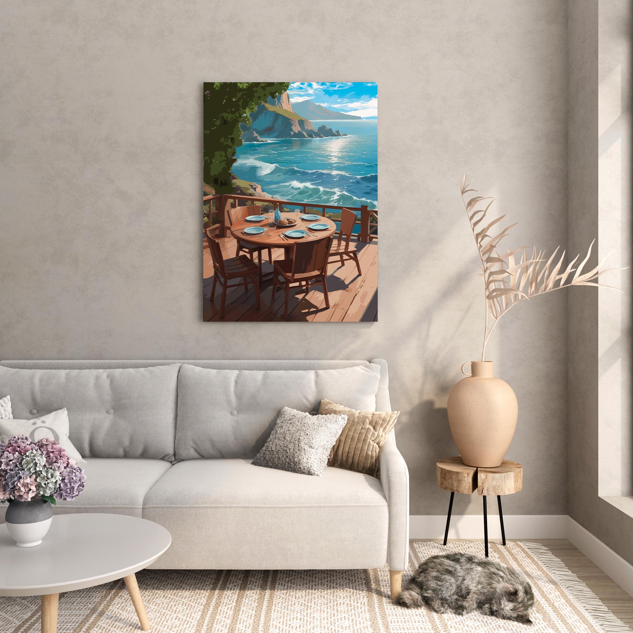 Scenic coastal printable wall art depicting a round wooden dining table set for five on a sunlit deck overlooking turquoise ocean waves and rocky cliffs under a bright blue sky, perfect for beach house, oceanview, or outdoor dining-inspired decor.