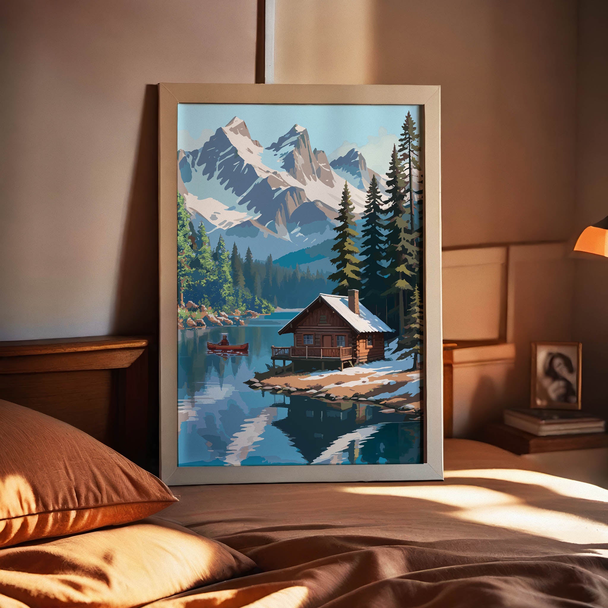 Rustic winter cabin printable wall art featuring a cozy log cabin on the edge of a tranquil lake, surrounded by snow-dusted pine trees and dramatic snow-covered mountain peaks, with a red canoe gliding across the water, perfect for cabin, adventure, or nature-inspired decor