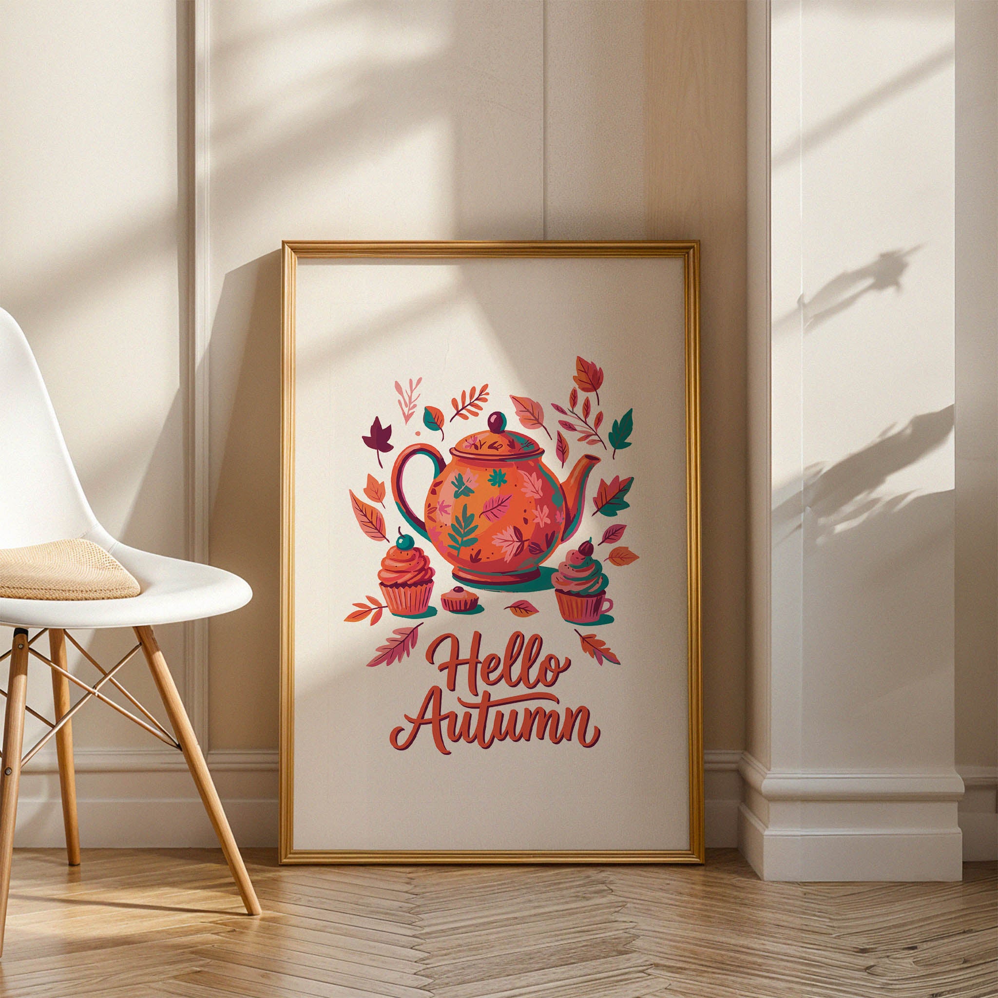 Close-up of a cozy fall tea print with teal-accented teapot illustration, pink frosted cupcakes, and multi-toned autumn leaf scatter on white with warm orange hand-lettered typography
