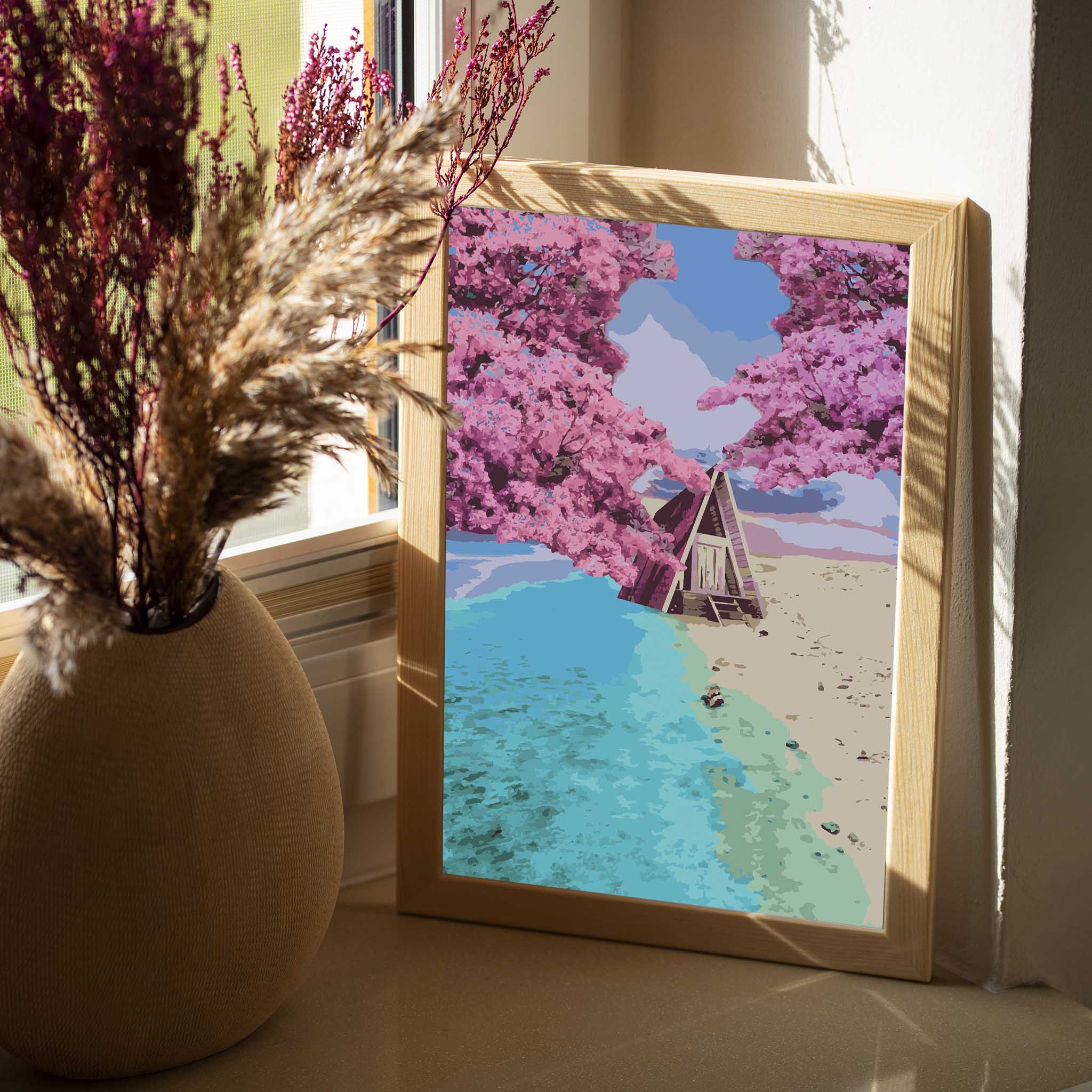 Whimsical beach cabin wall art featuring an A-frame hut nestled between turquoise ocean waves and golden sand, framed by blooming pink cherry blossom trees under a pastel sky