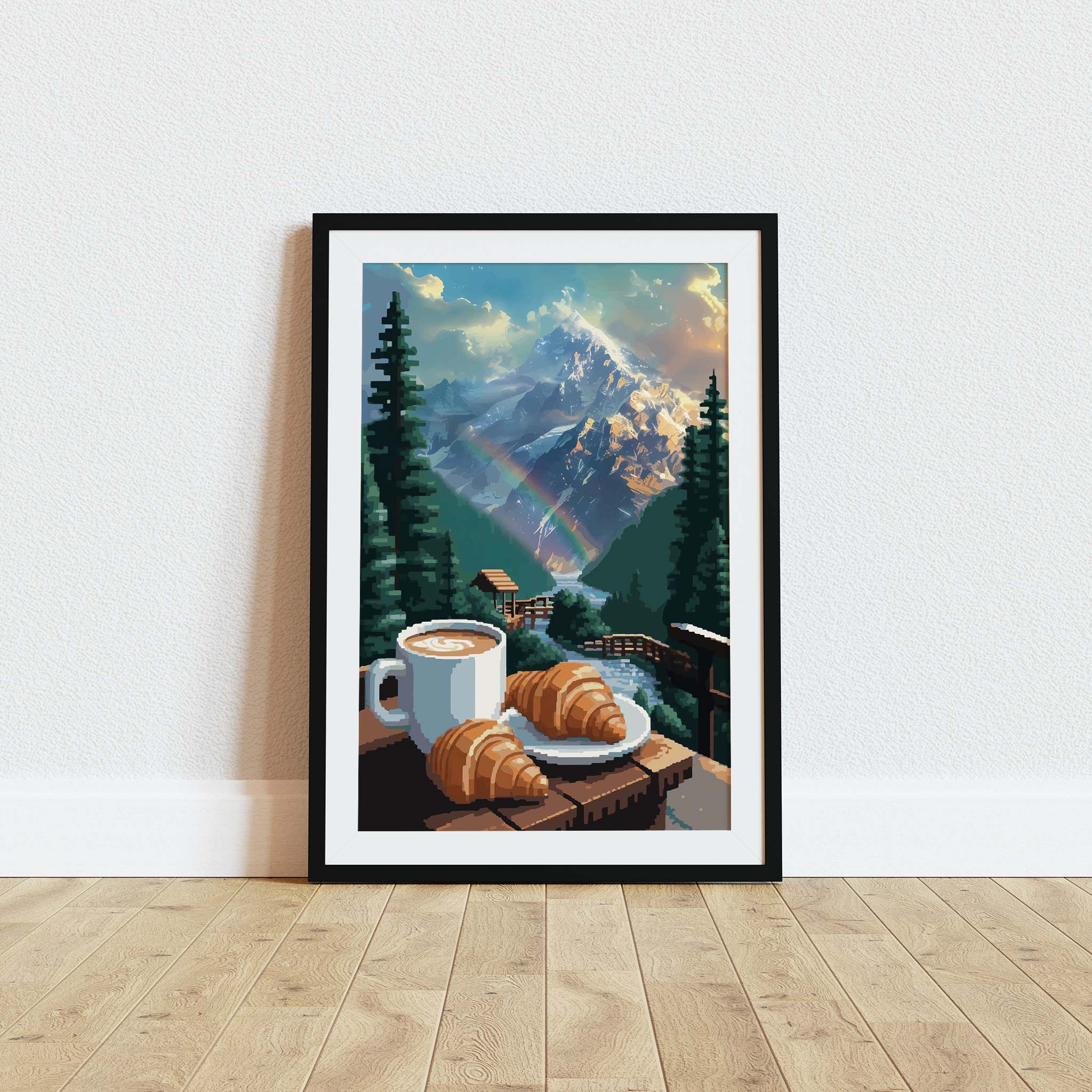 Cozy mountain-themed printable wall art featuring a cup of coffee and croissants on a wooden railing overlooking a flowing stream, lush pine trees, a rainbow, and majestic snow-covered peaks glowing in the morning light - perfect for cabin, breakfast nook, or nature lover decor