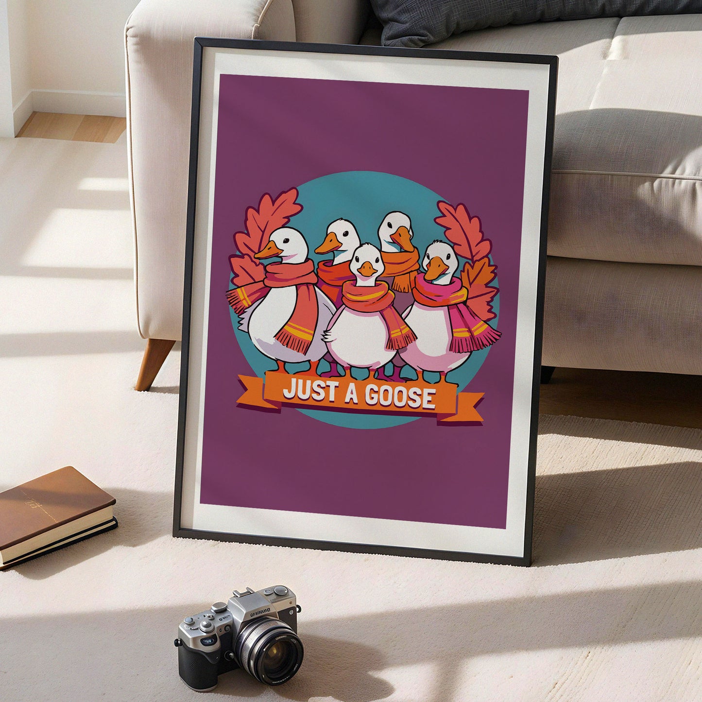 Close-up of a witty fall character print - five white geese wearing mismatched orange, magenta, and yellow-striped scarves posed as a squad beneath "Just a Goose" banner lettering on a plum and teal background