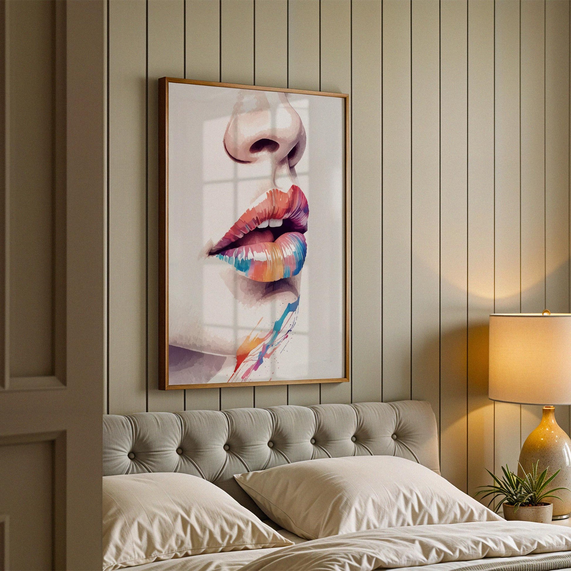 Close-up artistic portrait of glossy lips painted in a vibrant rainbow gradient of red, orange, yellow, blue, and purple tones. Soft splashes of colour extend below the lips, creating a bold, modern, and expressive pop-art style composition on a clean white background.