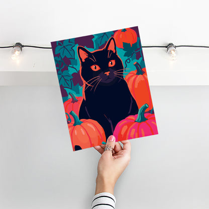 Close-up of a striking Halloween animal print - a black cat with vivid orange-red eyes and orange whisker highlights sits directly among pumpkins in orange and hot pink with teal stems against a moody teal vine background