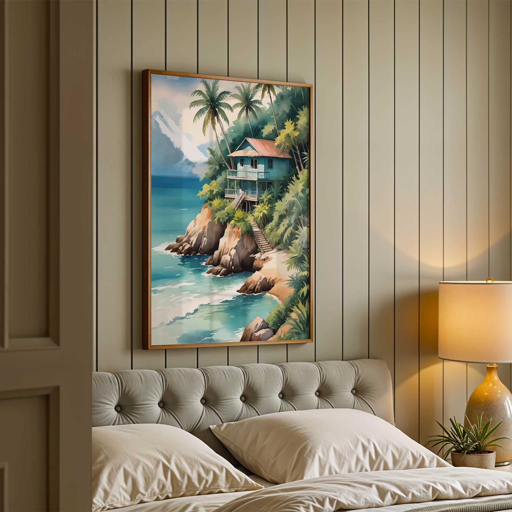 Tropical beach wall art of a wooden house on a cliff surrounded by palm trees, overlooking turquoise ocean waves with mountains in the background