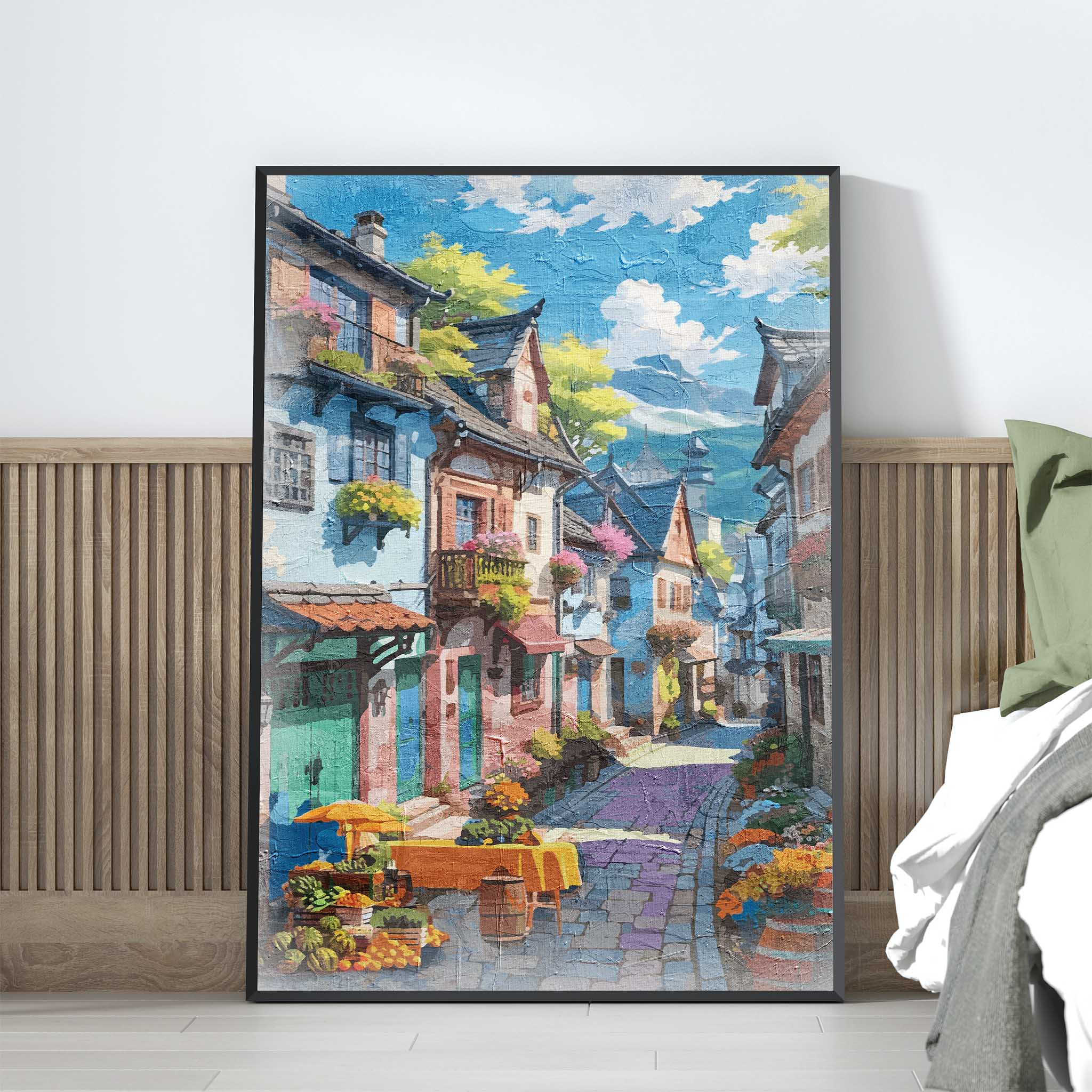 Charming printable wall art of a colorful European-style village street, lined with flower-filled balconies, cobblestone paths, and a market table with fruits and flowers under a sunny blue sky, perfect for travel-inspired, vintage, or Mediterranean-themed decor