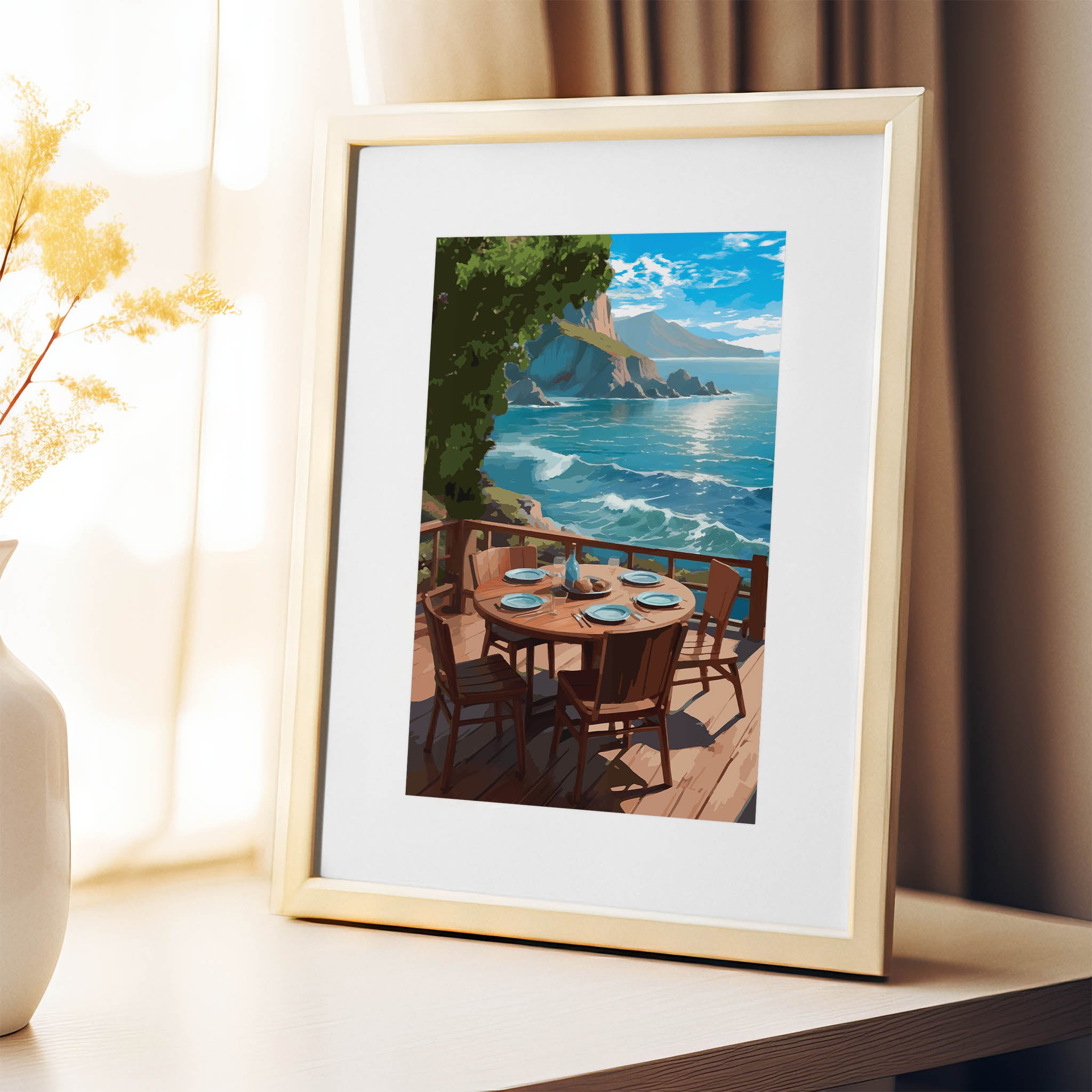 Scenic coastal printable wall art depicting a round wooden dining table set for five on a sunlit deck overlooking turquoise ocean waves and rocky cliffs under a bright blue sky, perfect for beach house, oceanview, or outdoor dining-inspired decor.