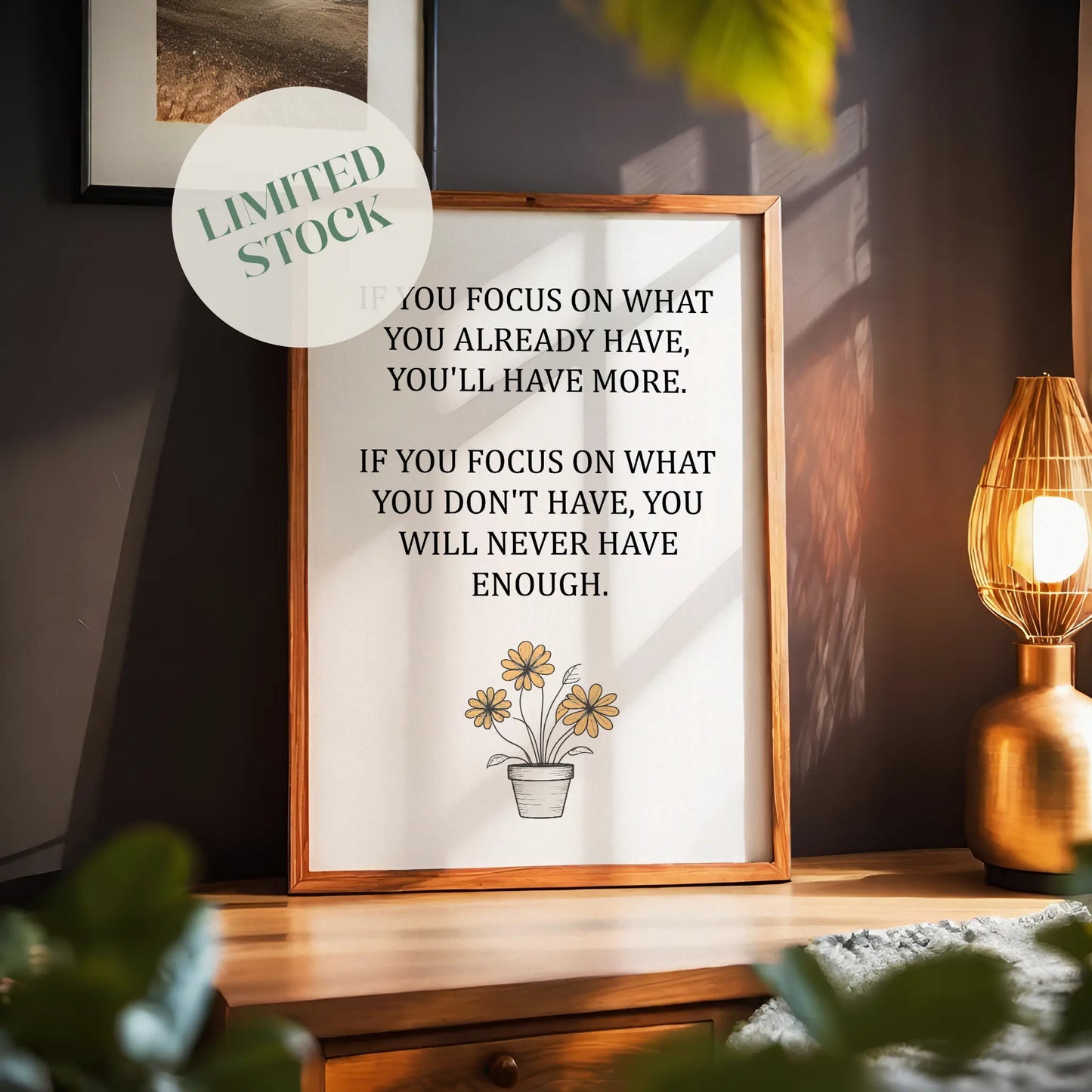 Inspirational printable wall art featuring the quote 'If you focus on what you already have, you'll have more. If you focus on what you don't have, you will never have enough,' with a simple daisy flower pot illustration and soft neutral background, ideal for gratitude-focused or minimalist decor