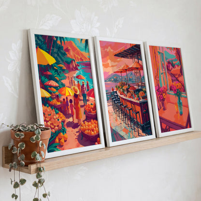 Three maximalist travel scene prints in white frames — a vibrant tropical fruit stall on a teal shoreline, a long coastal bar counter with orange umbrellas and mountain backdrop, and a warm pink interior with teal-framed windows and a bouquet