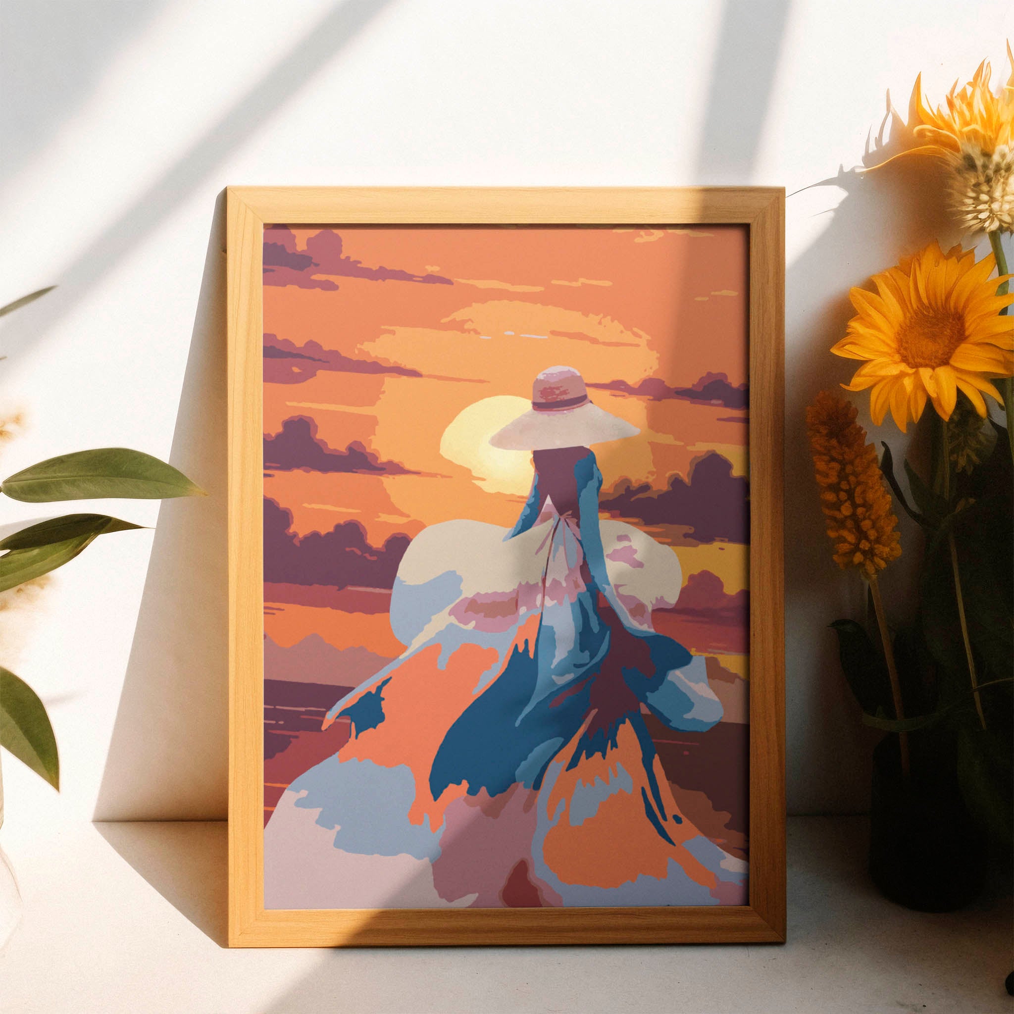 Romantic printable wall art featuring a woman in a flowing dress and wide-brimmed hat walking into a vibrant orange sunset, with abstract brushstrokes capturing movement, elegance, and a dreamy atmosphere
