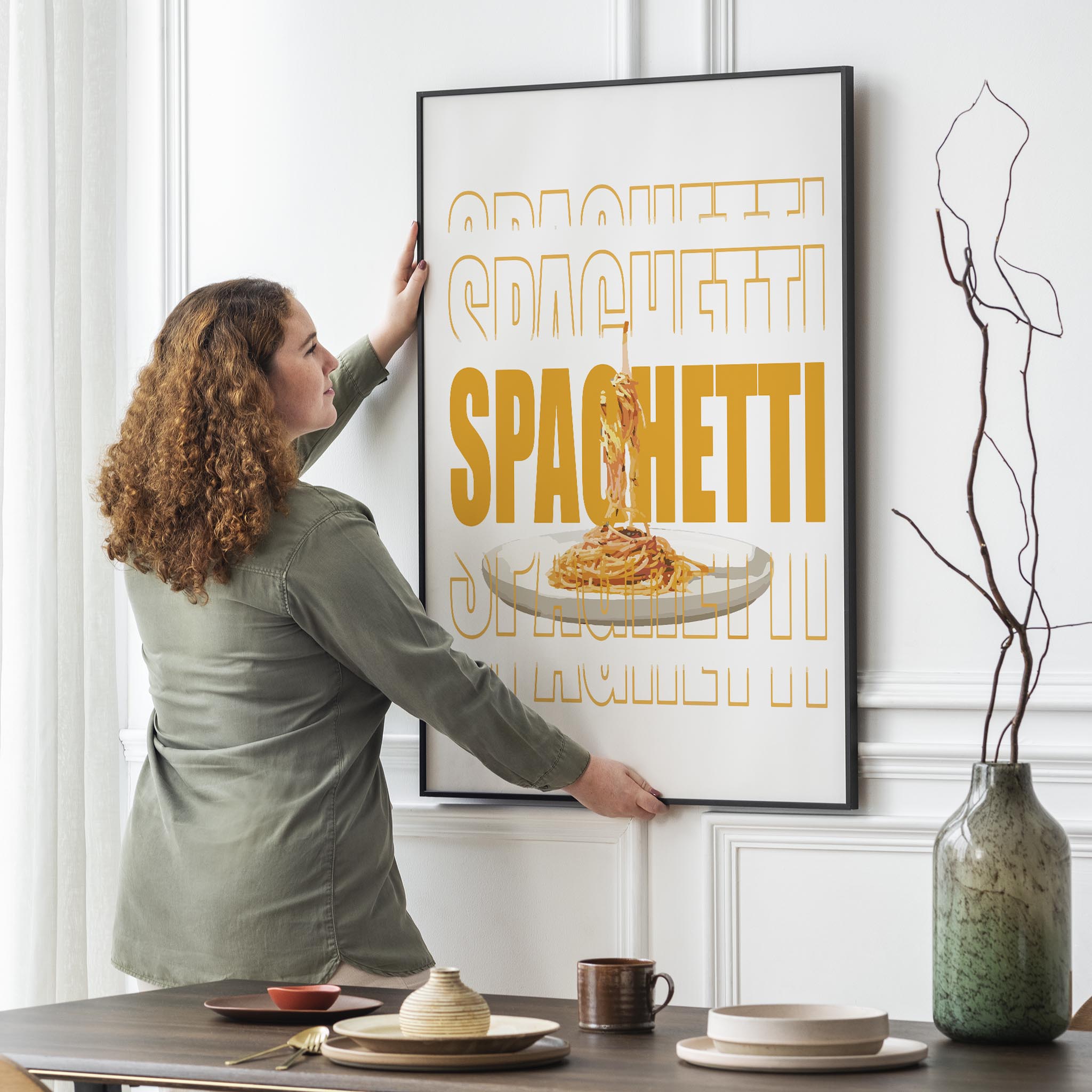 Modern printable wall art featuring a plate of spaghetti suspended mid-air, overlaid with bold, graphic text reading ‘SPAGHETTI’ in large orange typography, perfect for kitchen decor or food lovers