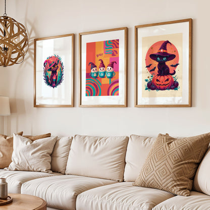 Styled shelf display of three bold Halloween character prints in white frames - a dark forest witch cat with candle flame, three smiling ghost figures in teal mugs on a retro colour-block background, and a cream-ground witch cat on a carved pumpkin