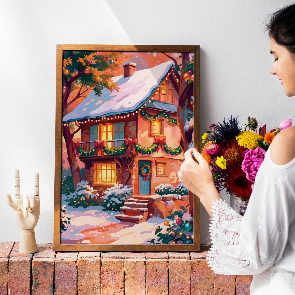 Maximalist Christmas landscape poster featuring a fully decorated stone cottage with glowing amber windows, teal shutters and door, cascading garland with red bows, a wreath, and snow-covered garden lit by warm string lights under a pink and orange winter sky