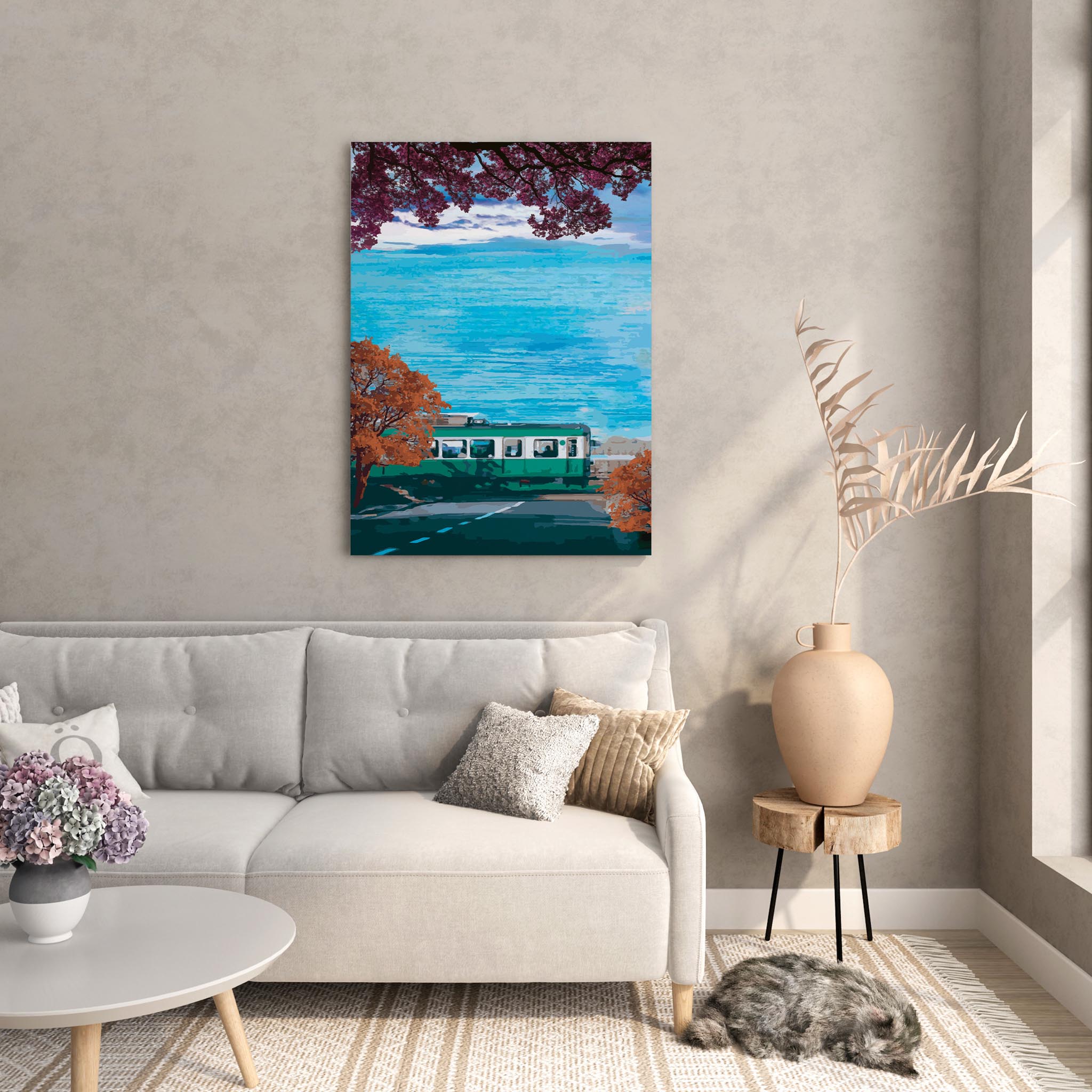 Scenic travel wall art featuring a green train passing along a coastal road lined with autumn trees, with vibrant blue ocean waves and a distant Mount Fuji under a partly cloudy sky.