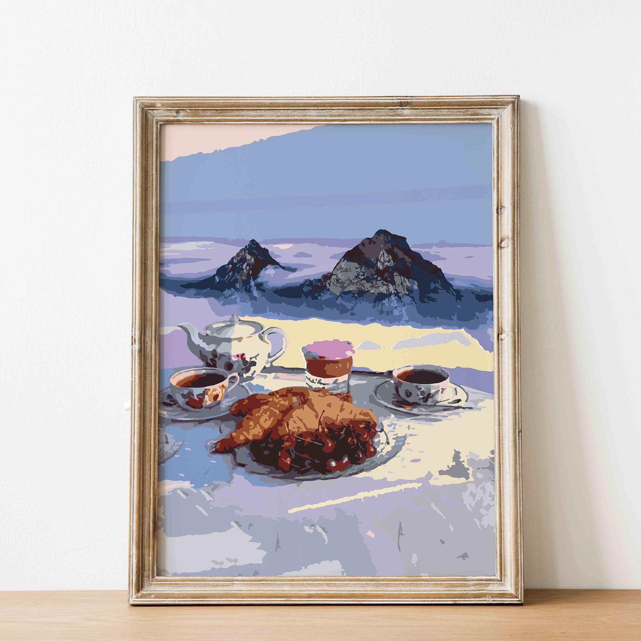 Cozy printable wall art of a serene alpine breakfast scene featuring croissants, tea, and coffee with a majestic mountain backdrop, perfect for kitchen or café-inspired decor