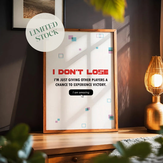 Funny gaming quote wall art stating ‘I don’t lose, I’m just giving other players a chance to experience victory’ in bold gamer typography with playful geometric accents - ideal decor for gaming rooms and streamers