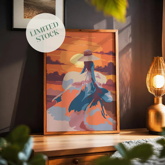 Romantic printable wall art featuring a woman in a flowing dress and wide-brimmed hat walking into a vibrant orange sunset, with abstract brushstrokes capturing movement, elegance, and a dreamy atmosphere