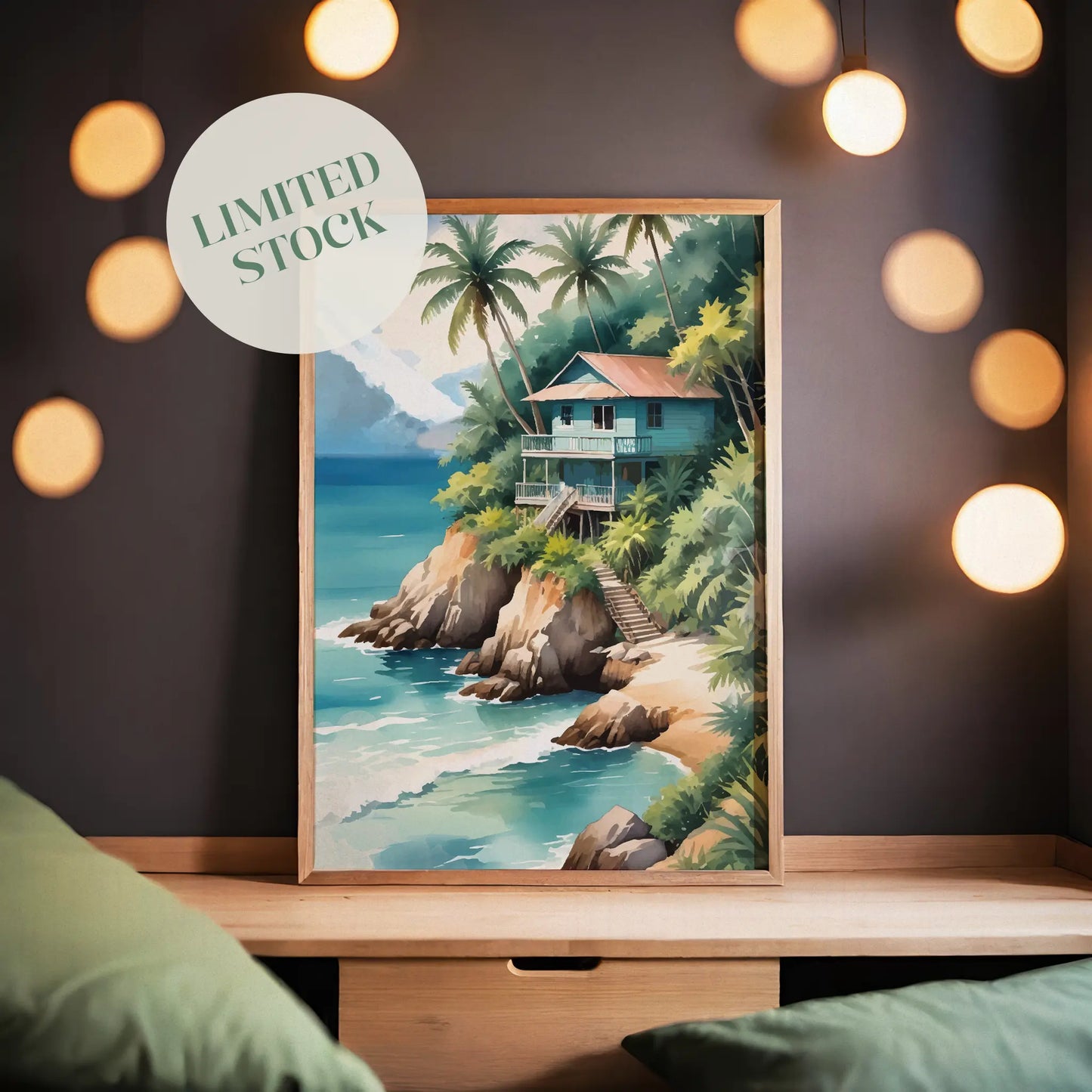 Tropical beach wall art of a wooden house on a cliff surrounded by palm trees, overlooking turquoise ocean waves with mountains in the background