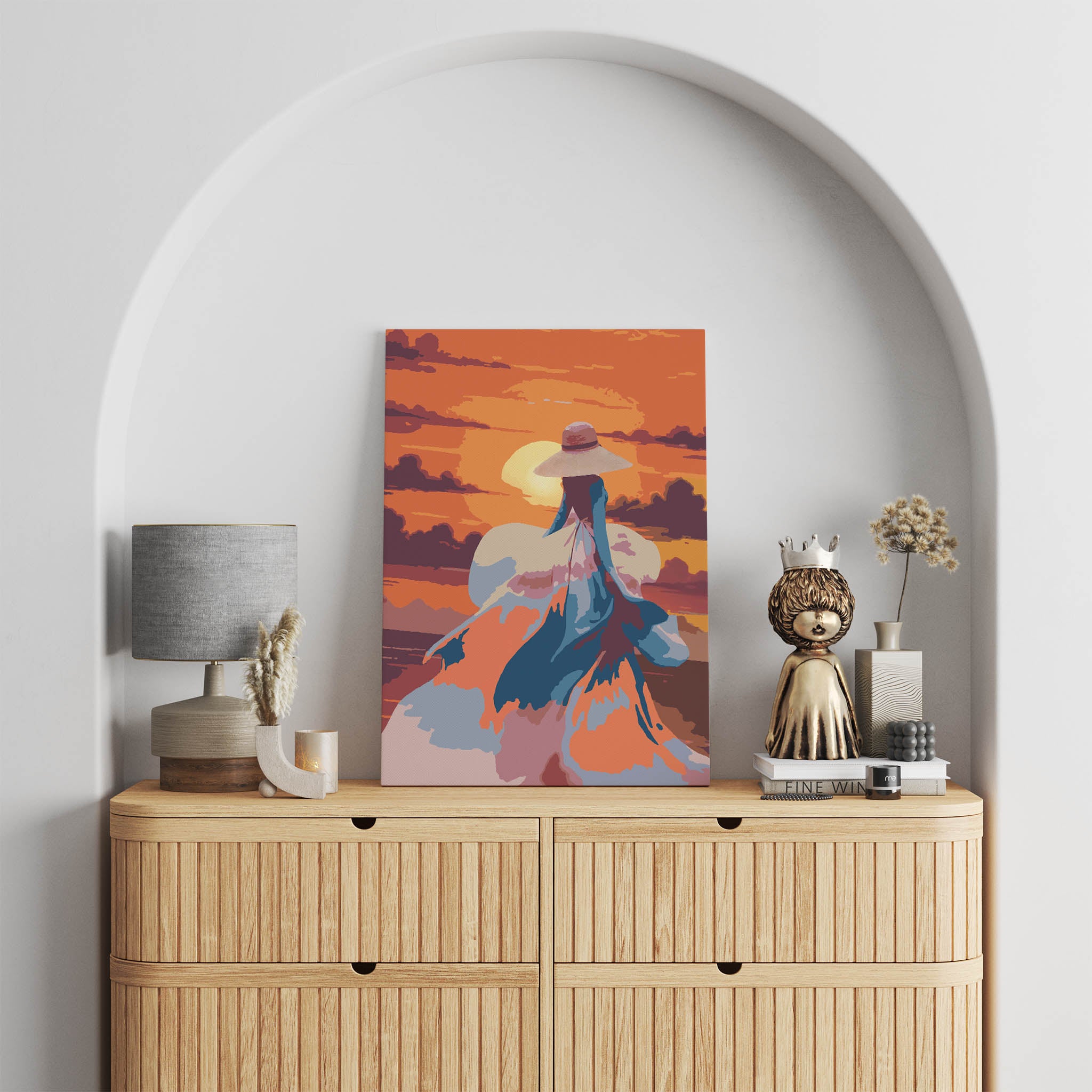 Romantic printable wall art featuring a woman in a flowing dress and wide-brimmed hat walking into a vibrant orange sunset, with abstract brushstrokes capturing movement, elegance, and a dreamy atmosphere