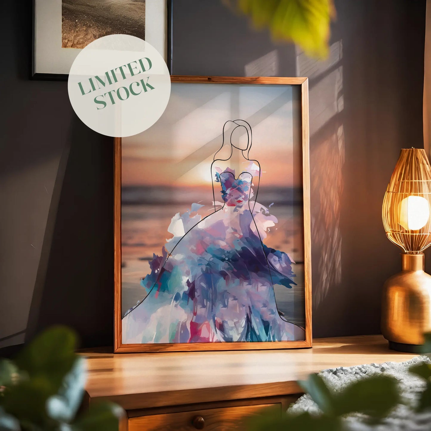 Elegant printable wall art featuring a minimalist line drawing of a woman in a flowing, abstract watercolour gown with vibrant purples, blues, and pinks, set against a serene sunset beach background, perfect for modern, fashion-inspired interiors